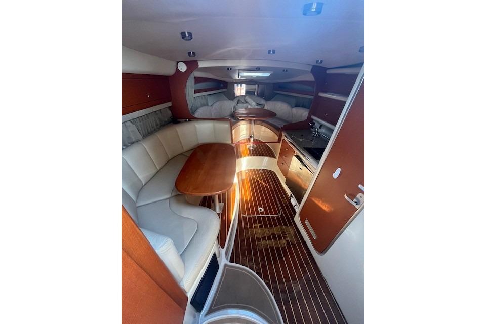2005 Chaparral 290 Signature cabin interior with wood flooring and cozy seating area.