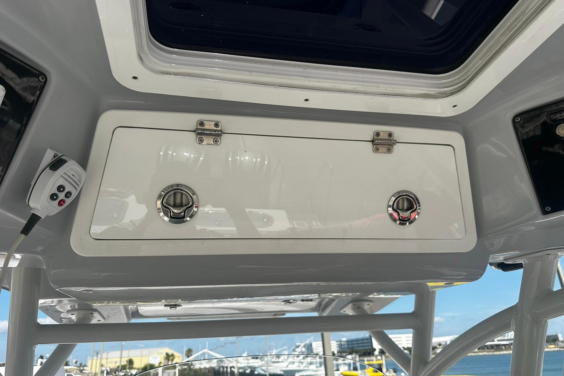Storage compartment on a 2002 Sea Fox 228 Commander boat, with ocean view background.