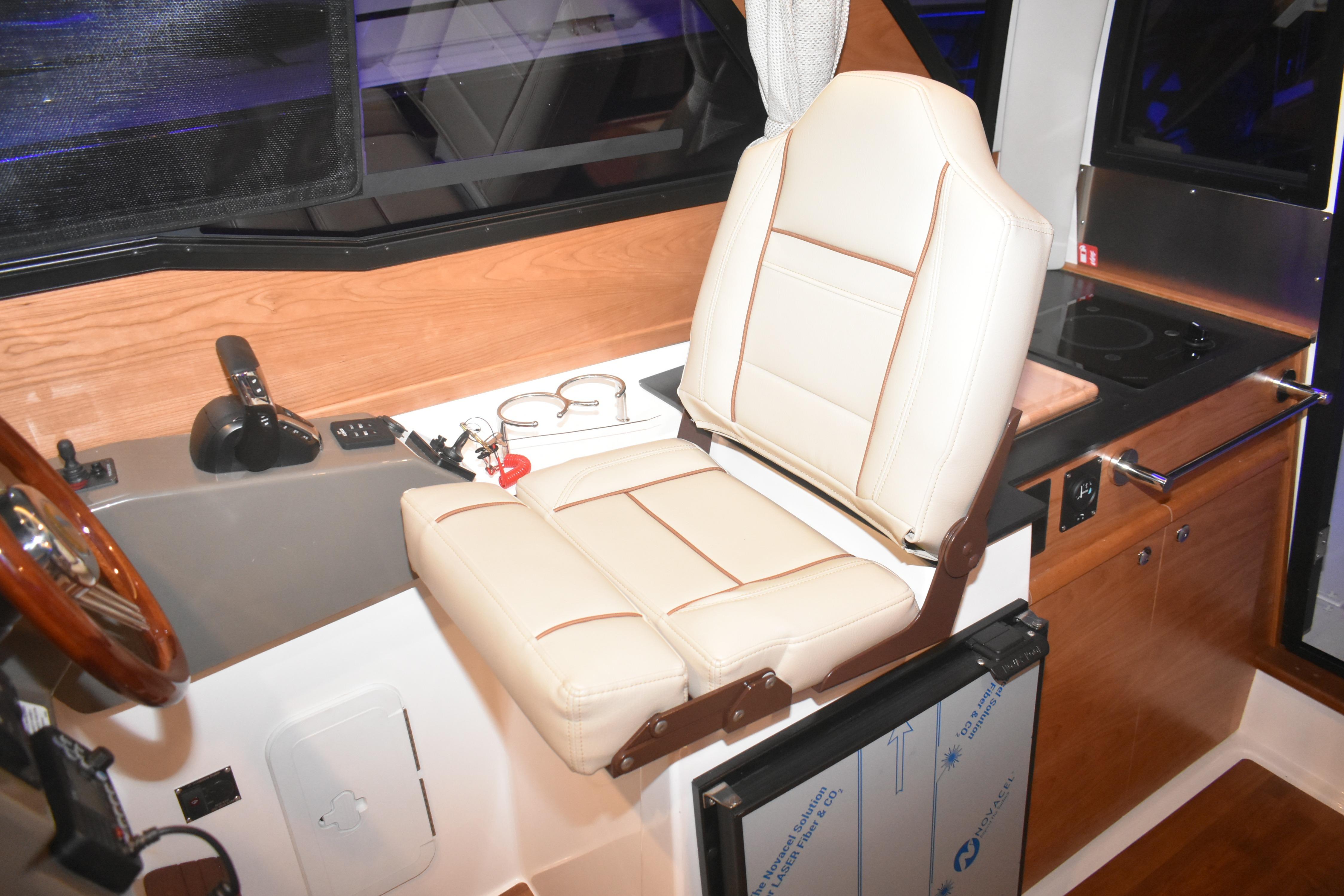Interior of 2026 Cutwater C-248 Coupe featuring helm seat and control panel.