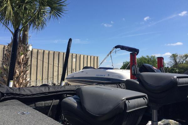 2020 Nitro ZV21 boat docked near palm tree under clear blue sky.