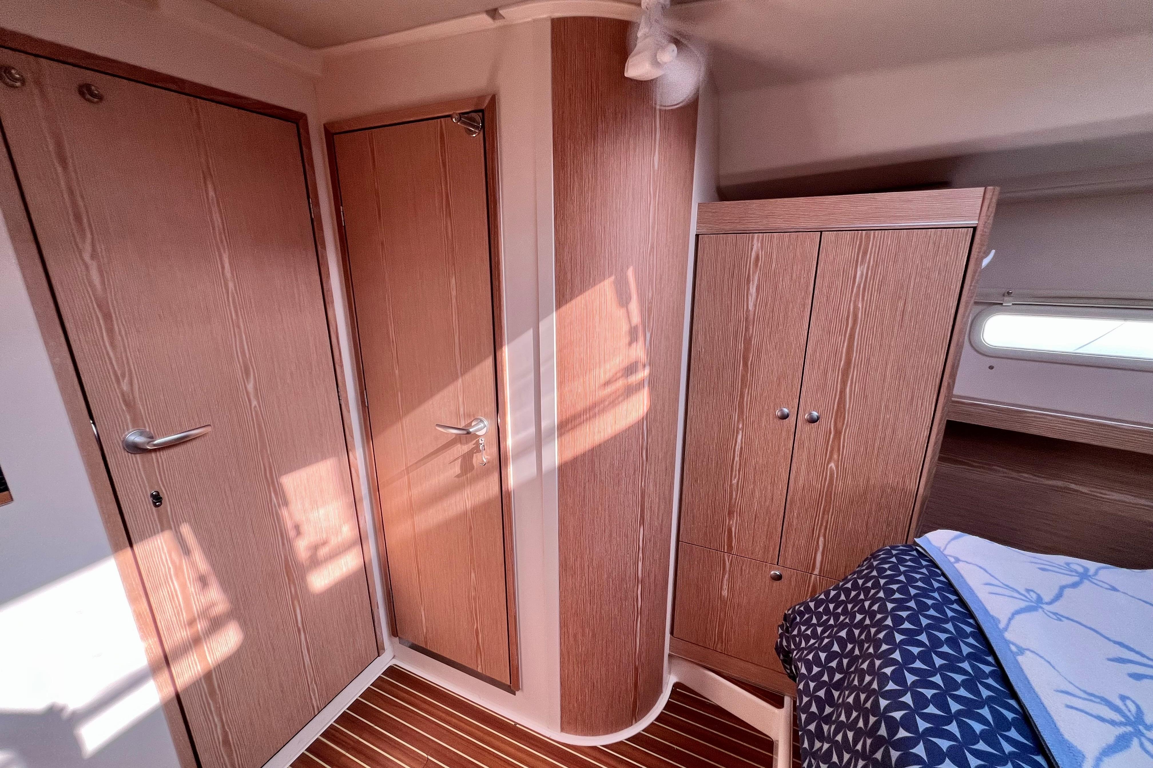 Interior of 2016 Hanse 455 yacht with wooden cabinetry and modern design.