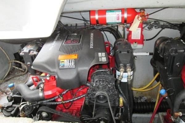 2004 Crownline 288 BR engine compartment with visible fire extinguisher and wiring.