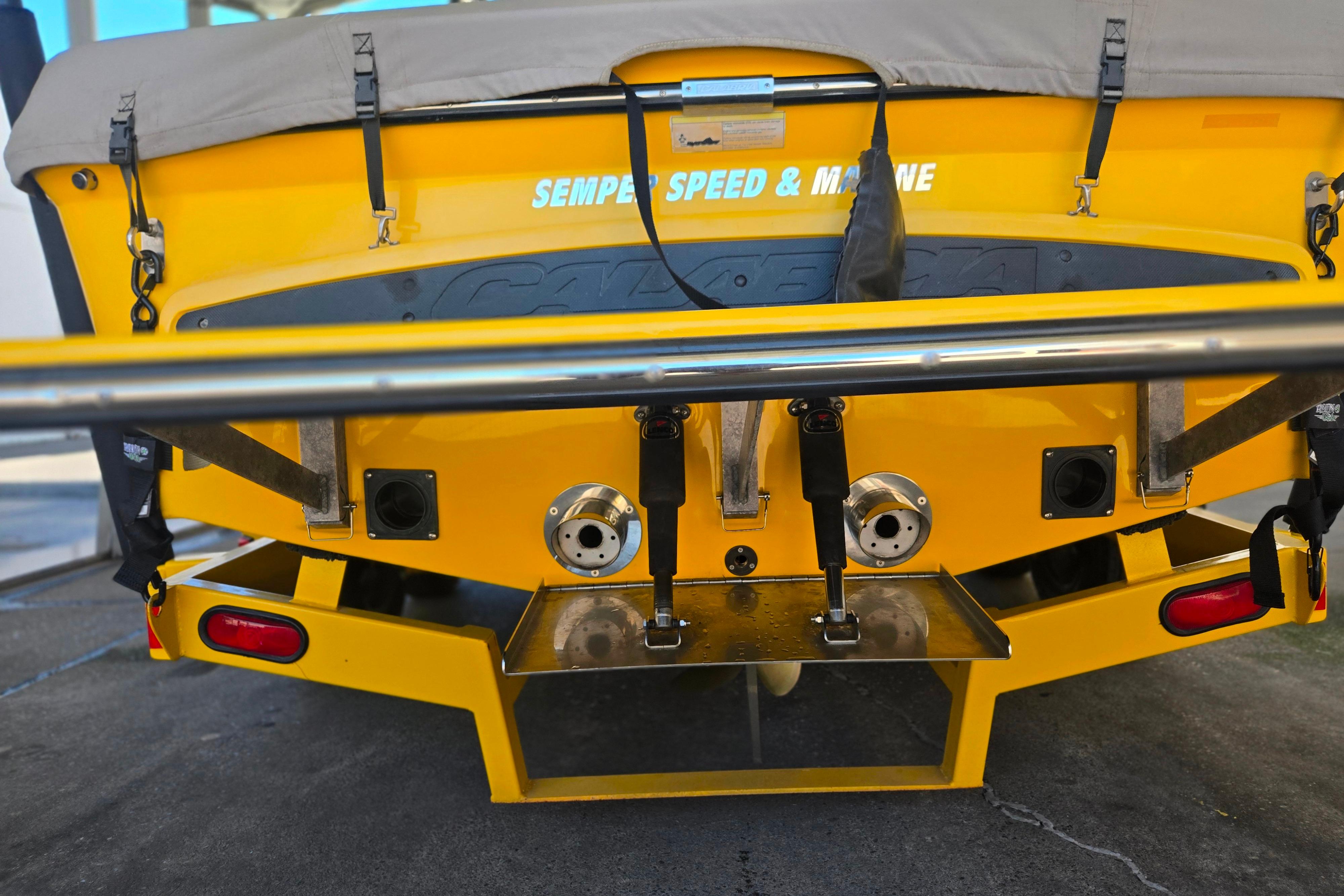 Rear view of a 2007 Calabria CAL AIR PRO V boat, featuring vibrant yellow color.