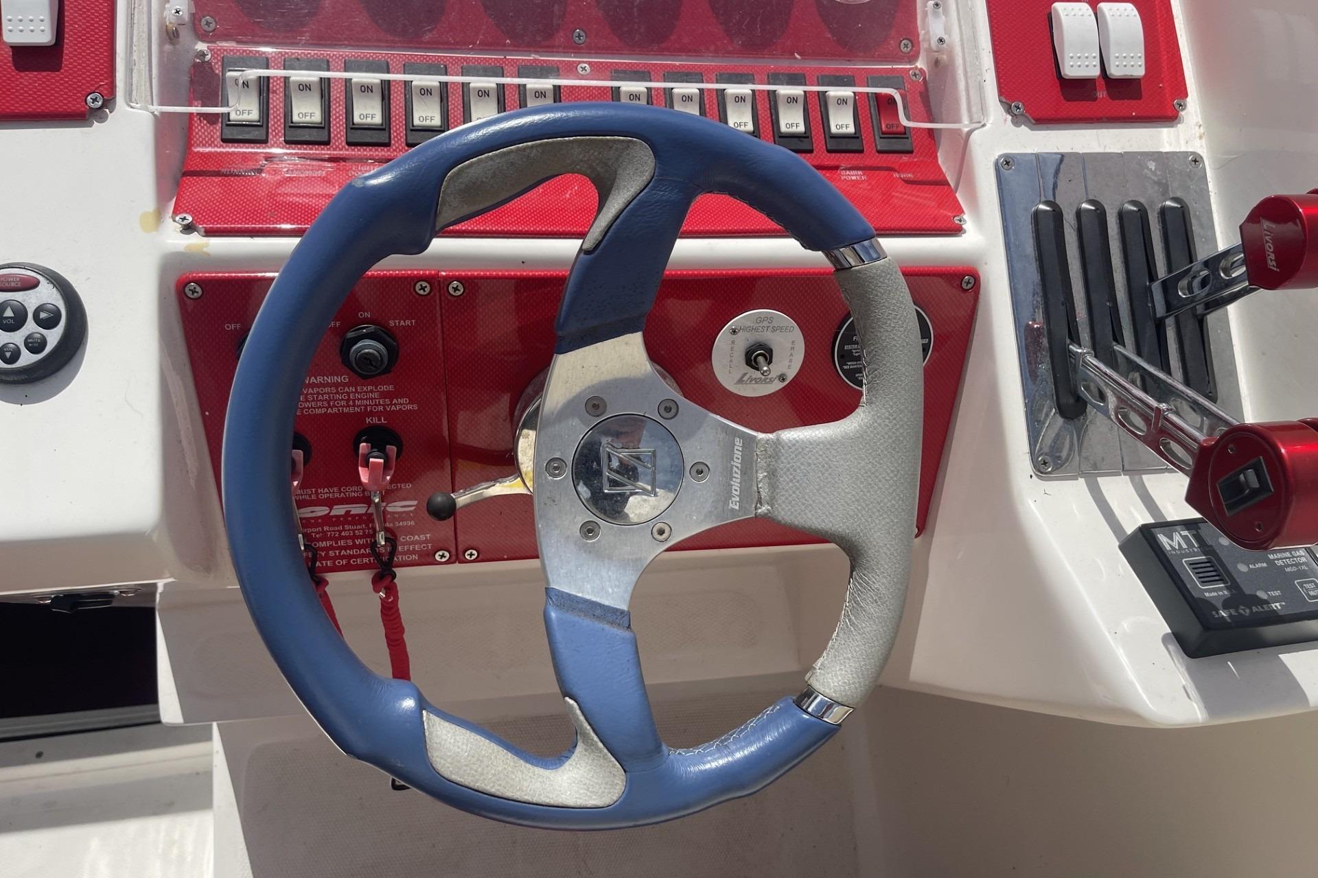Steering wheel and controls of a 2006 Sonic 386 boat cockpit.