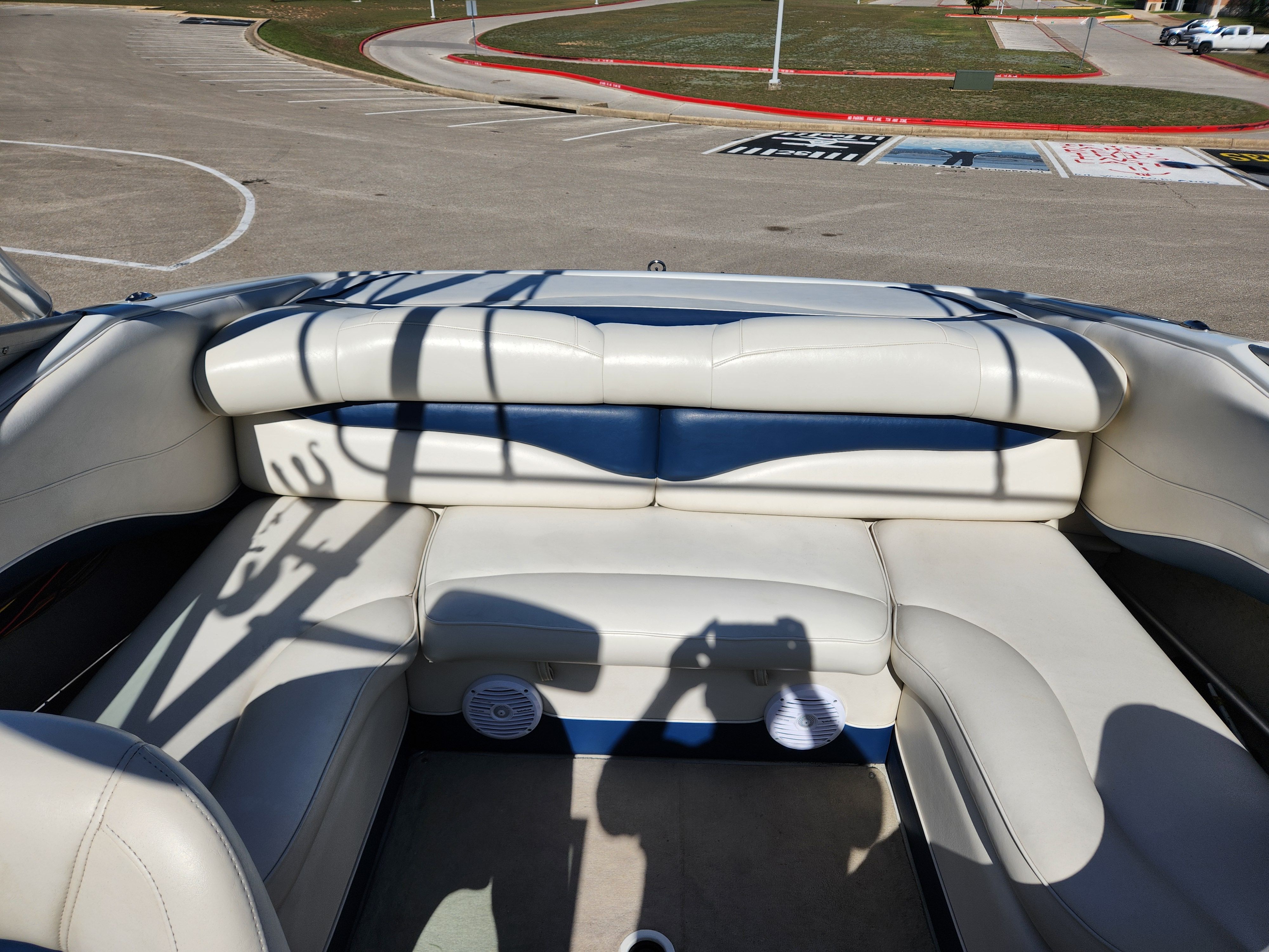 Interior of a 2003 Crownline 225 BR boat with white seating.