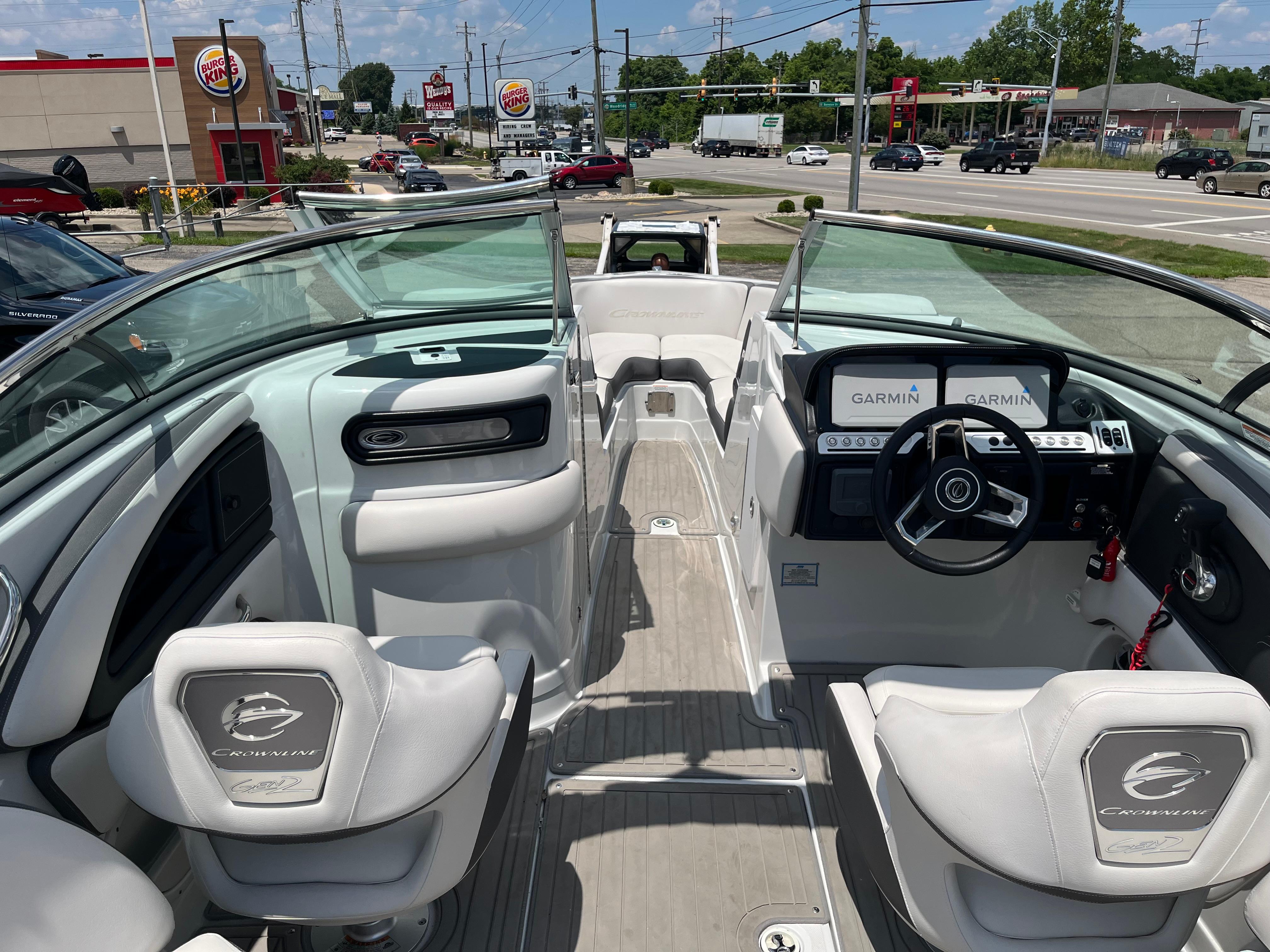 2022 Crownline 280 SS boat interior with Garmin navigation, parked near a Burger King.