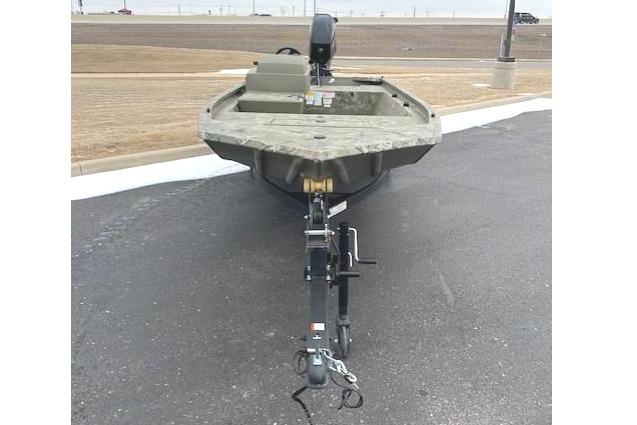 2025 Tracker Grizzly 1648 SC boat on trailer, parked on asphalt.