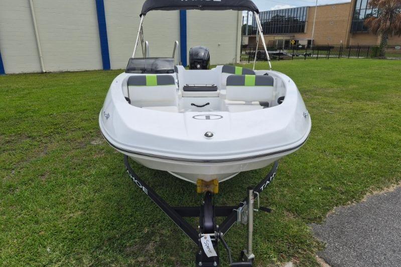 2021 Tahoe T16 boat on trailer, parked on grass near buildings.