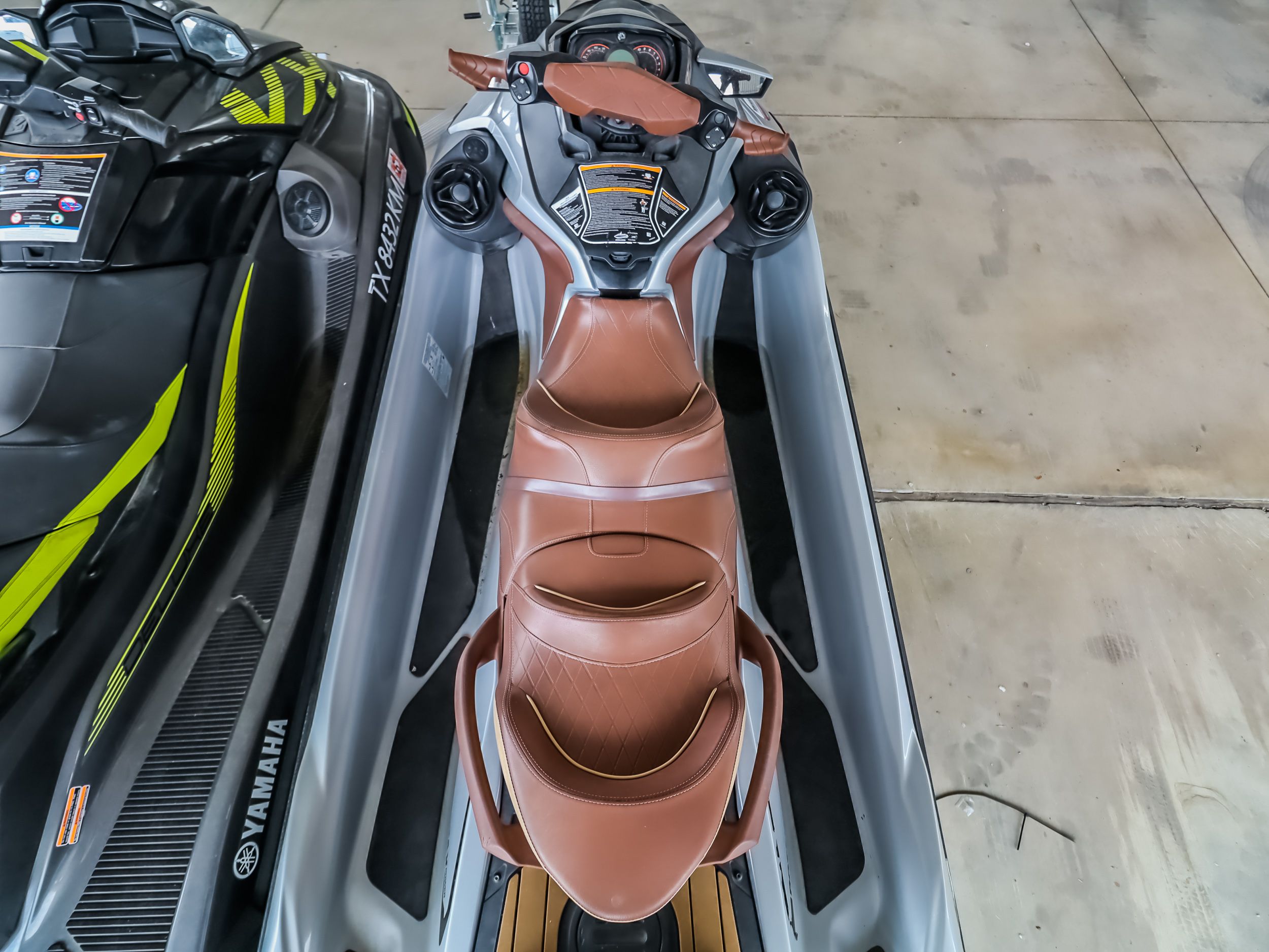 2018 Sea-Doo GTX300 jet ski with brown seat, parked in a garage.