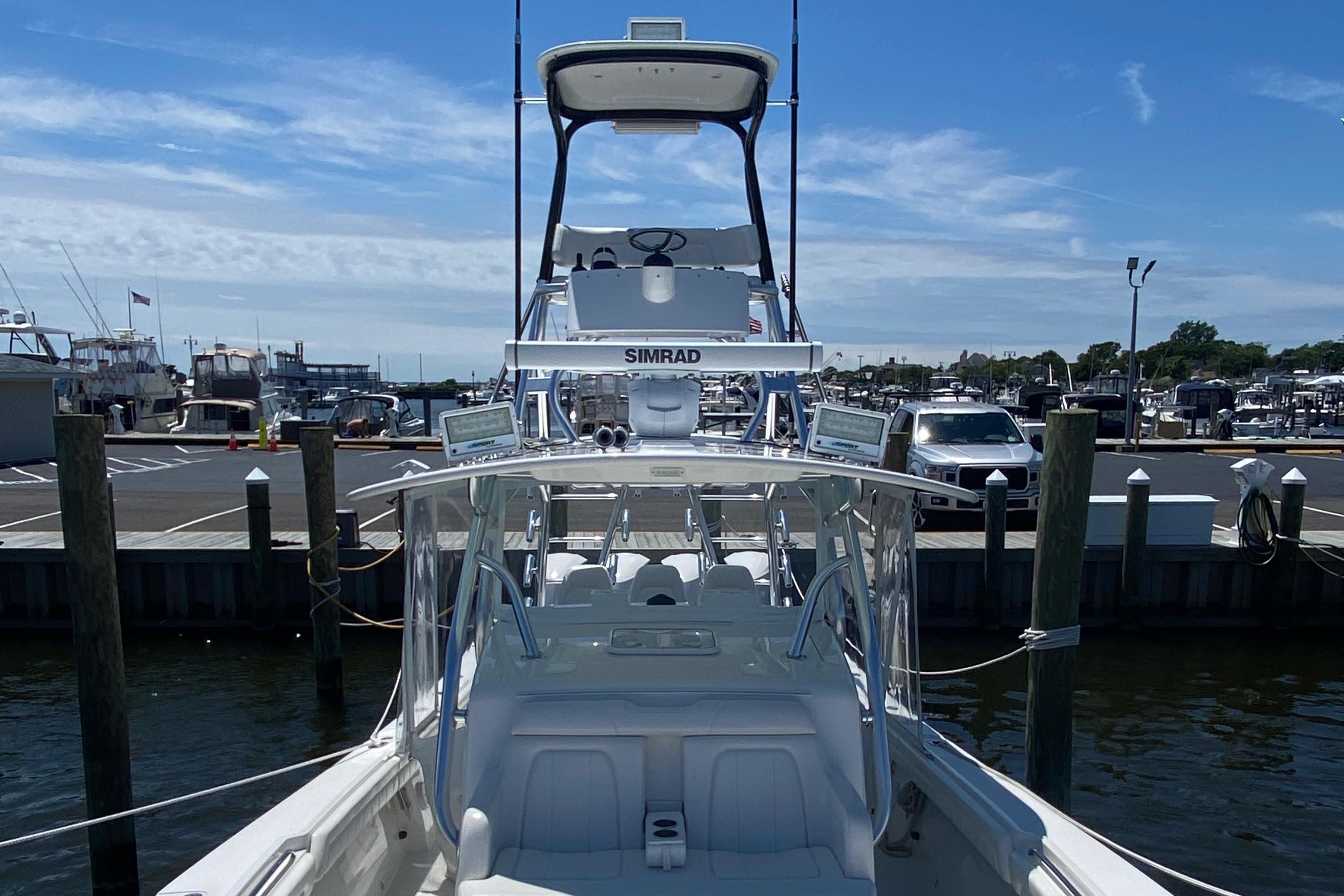 2016 Regulator 41 boat docked at marina, featuring Simrad electronics and a clear blue sky.