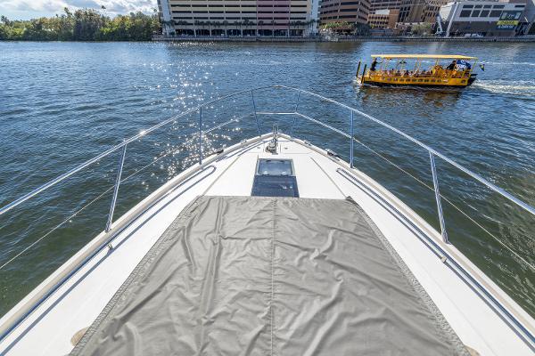 2013 Princess V57 yacht on water with city view.