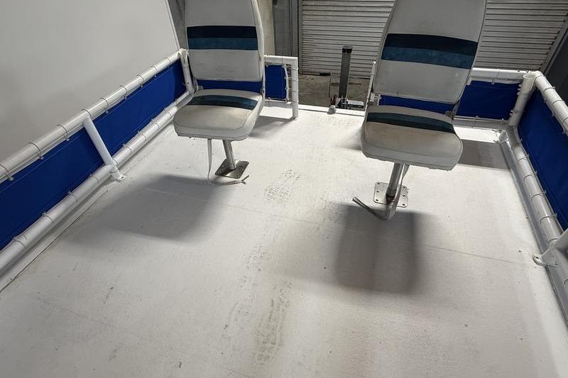 1993 Monark Sun Caster 240 CR 4 Point boat interior with two swivel seats.