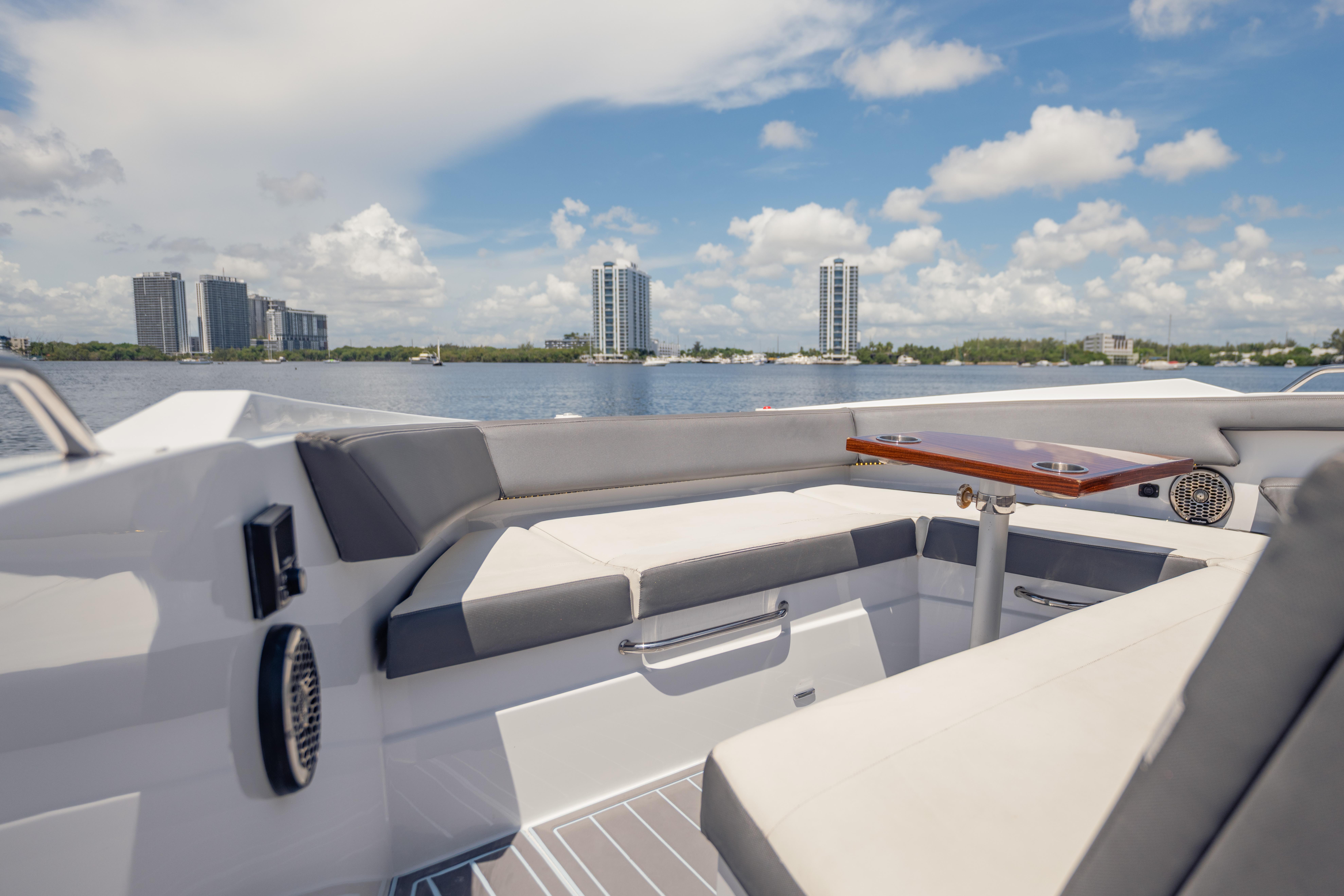 Luxurious 2021 Cruisers Yachts 38 GLS interior with waterfront cityscape view.