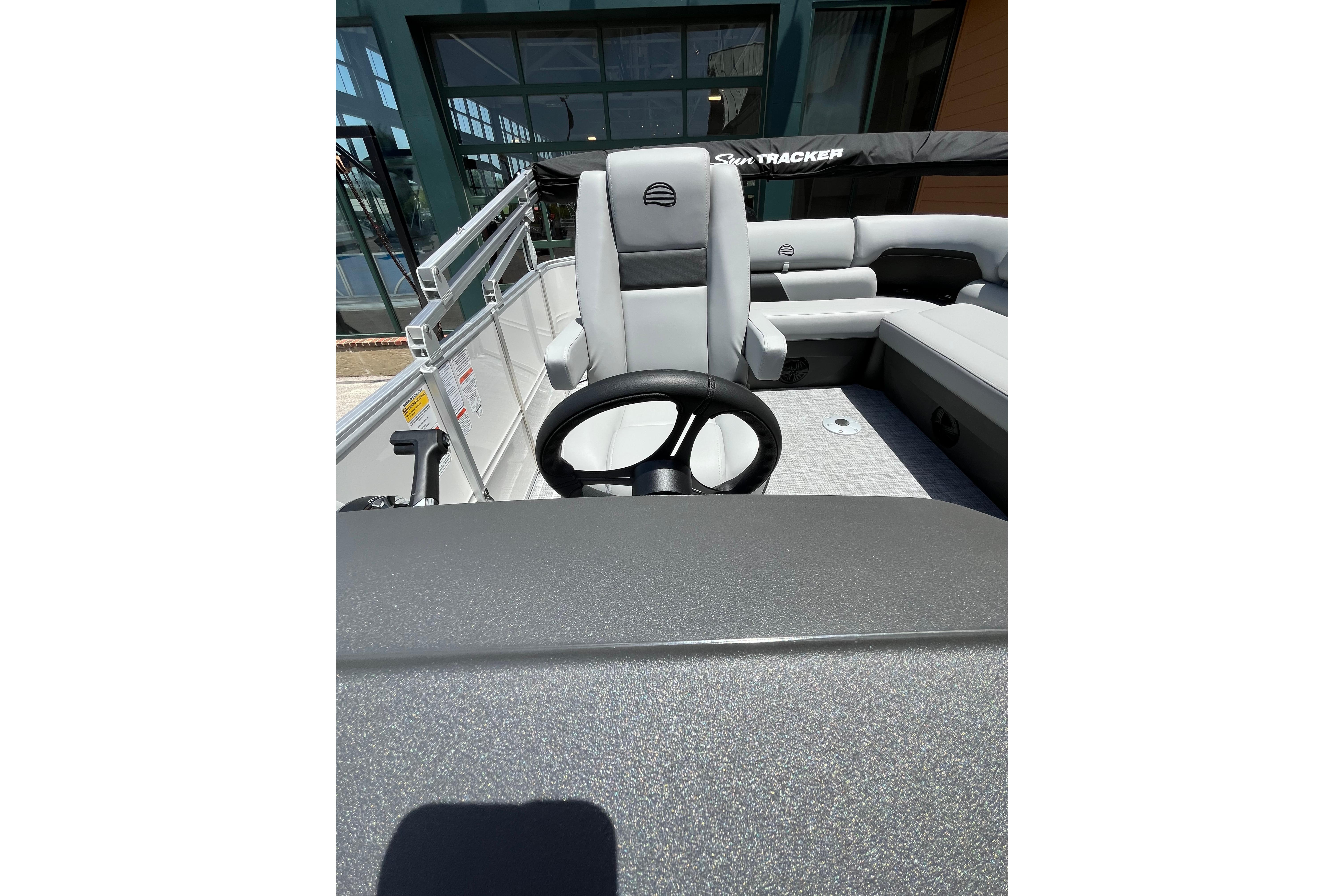 2026 Sun Tracker Party Barge 20 DLX interior with steering wheel and seating.