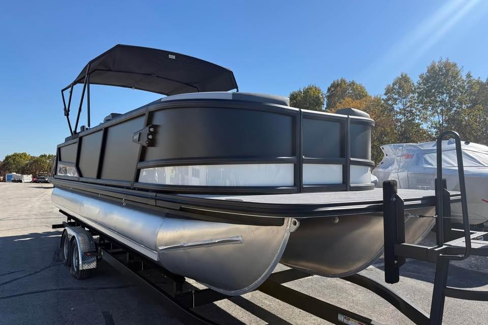 2026 Alera M 25Q pontoon boat on trailer under clear blue sky.