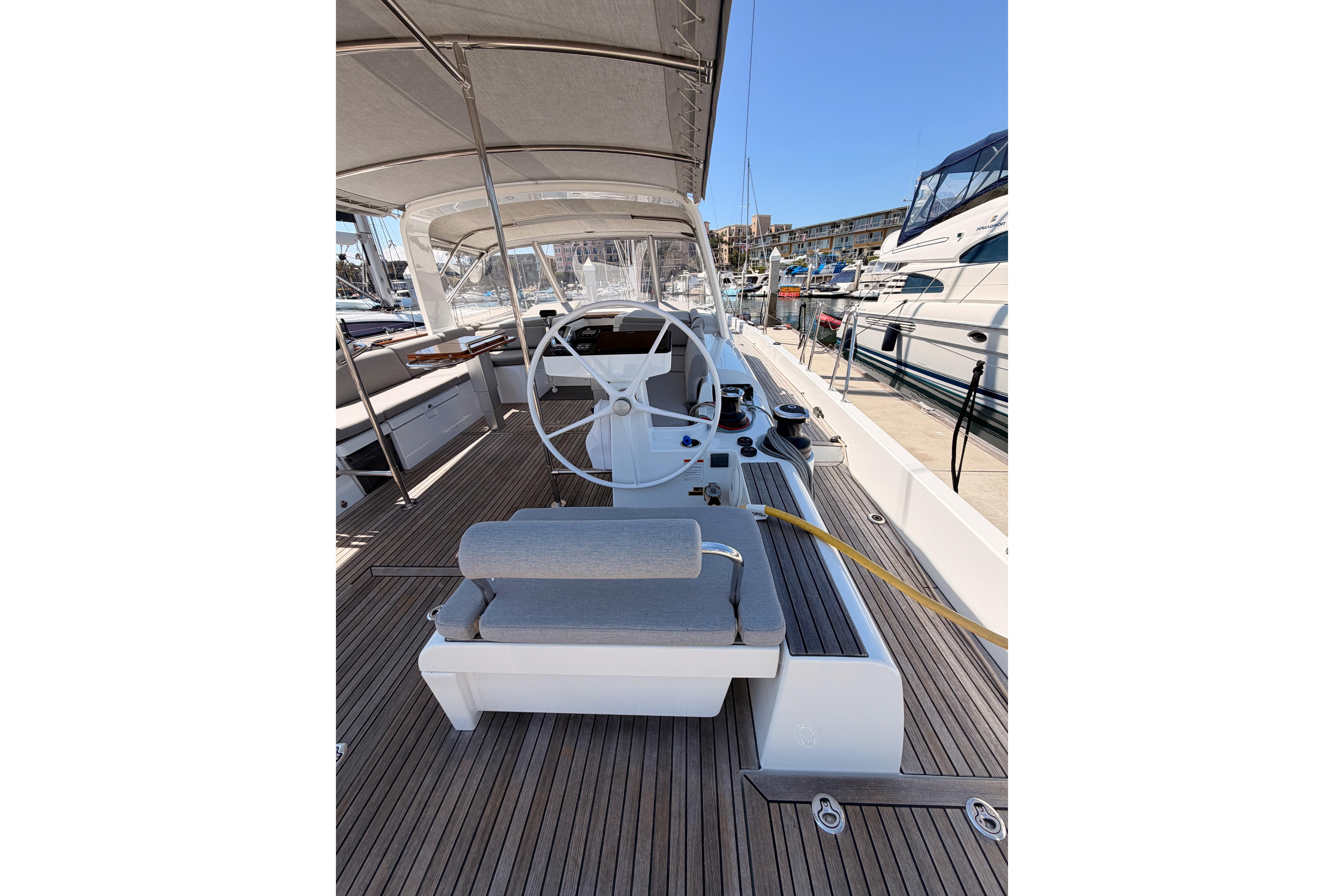Cockpit of 2022 Beneteau Oceanis Yacht 54 with steering wheel and seating.
