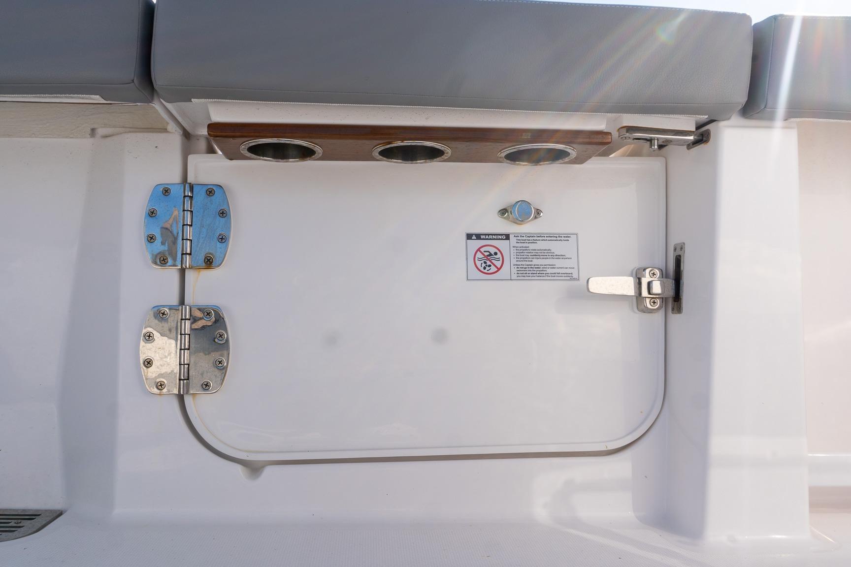 2024 Everglades 395 Center Console boat hatch with stainless steel hinges and warning label.