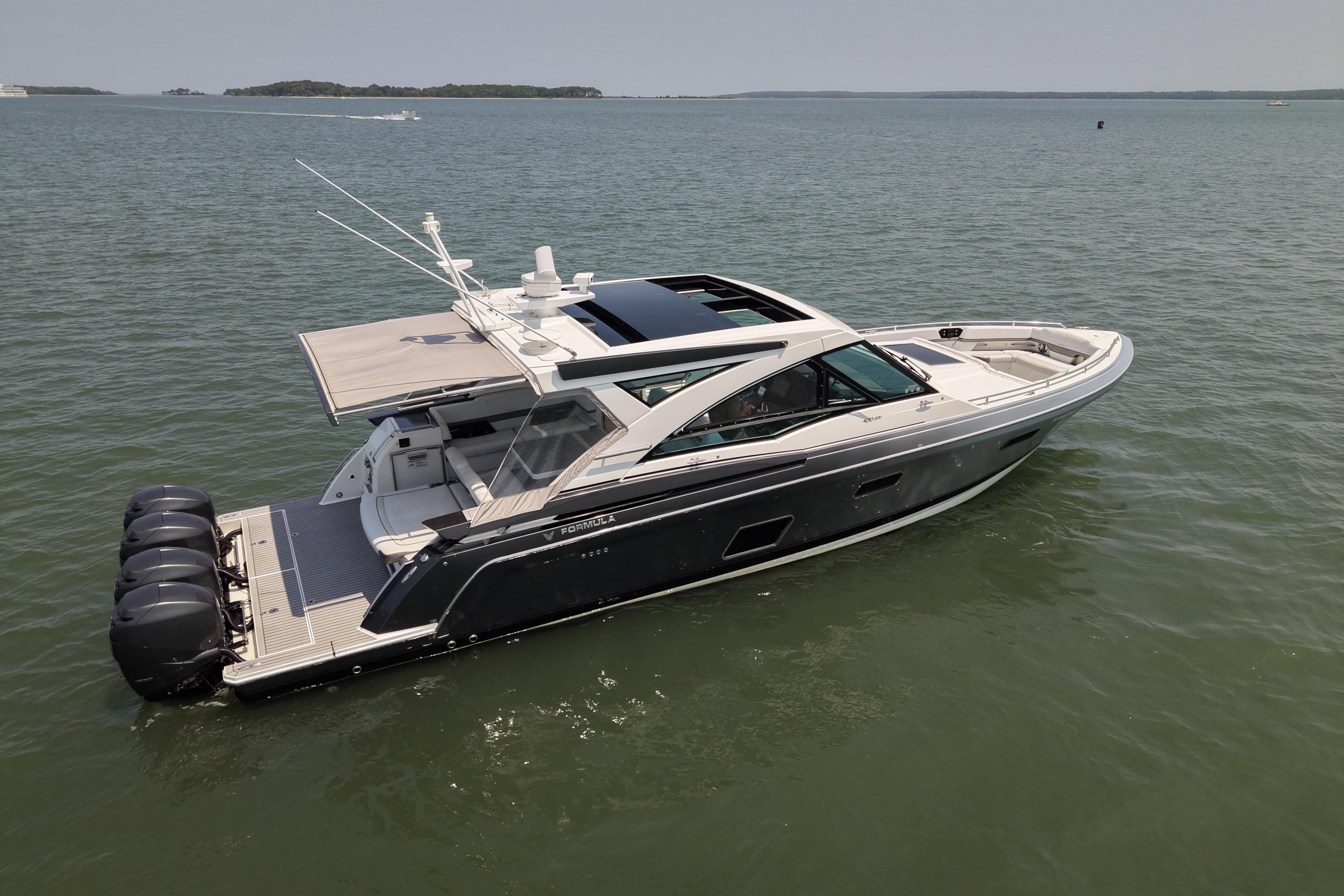 2019 Formula 430 Super Sport Crossover boat on calm water, showcasing sleek design and powerful engines.