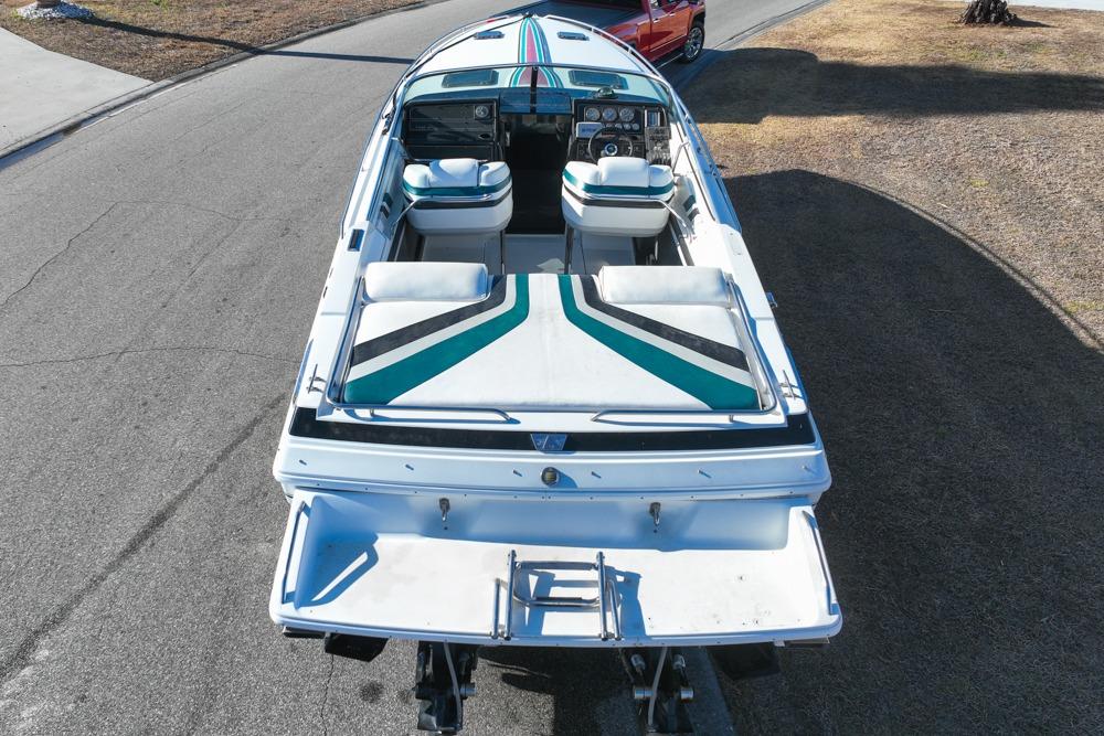 1989 Formula 292 SR-1 speedboat with striped upholstery, parked on a road.
