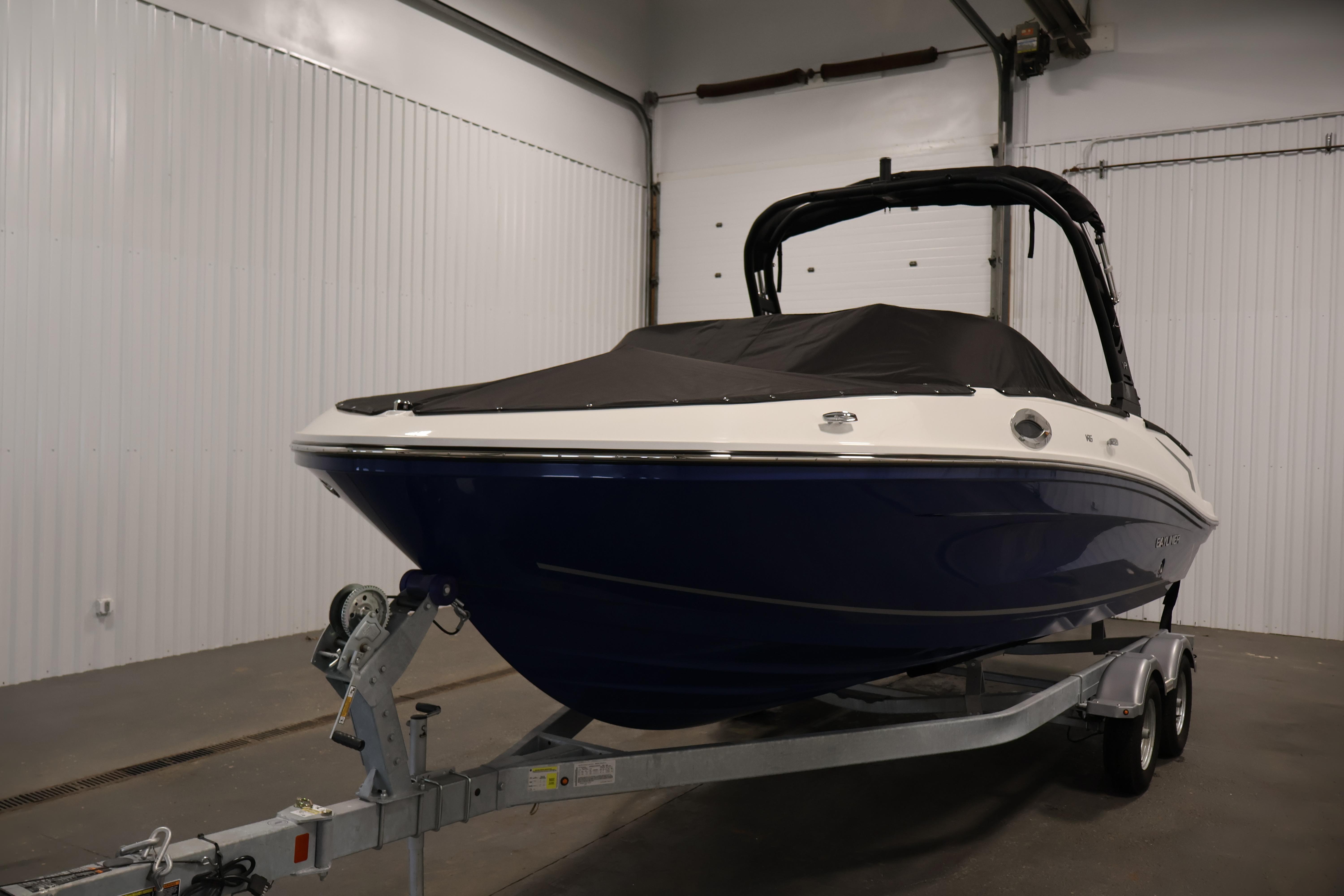 2026 Bayliner VR6 Bowrider I/O boat on trailer in indoor storage.