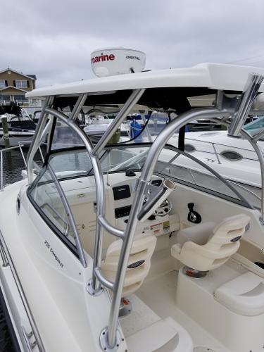 2011 Boston Whaler 235 Conquest boat with radar, docked in a marina.