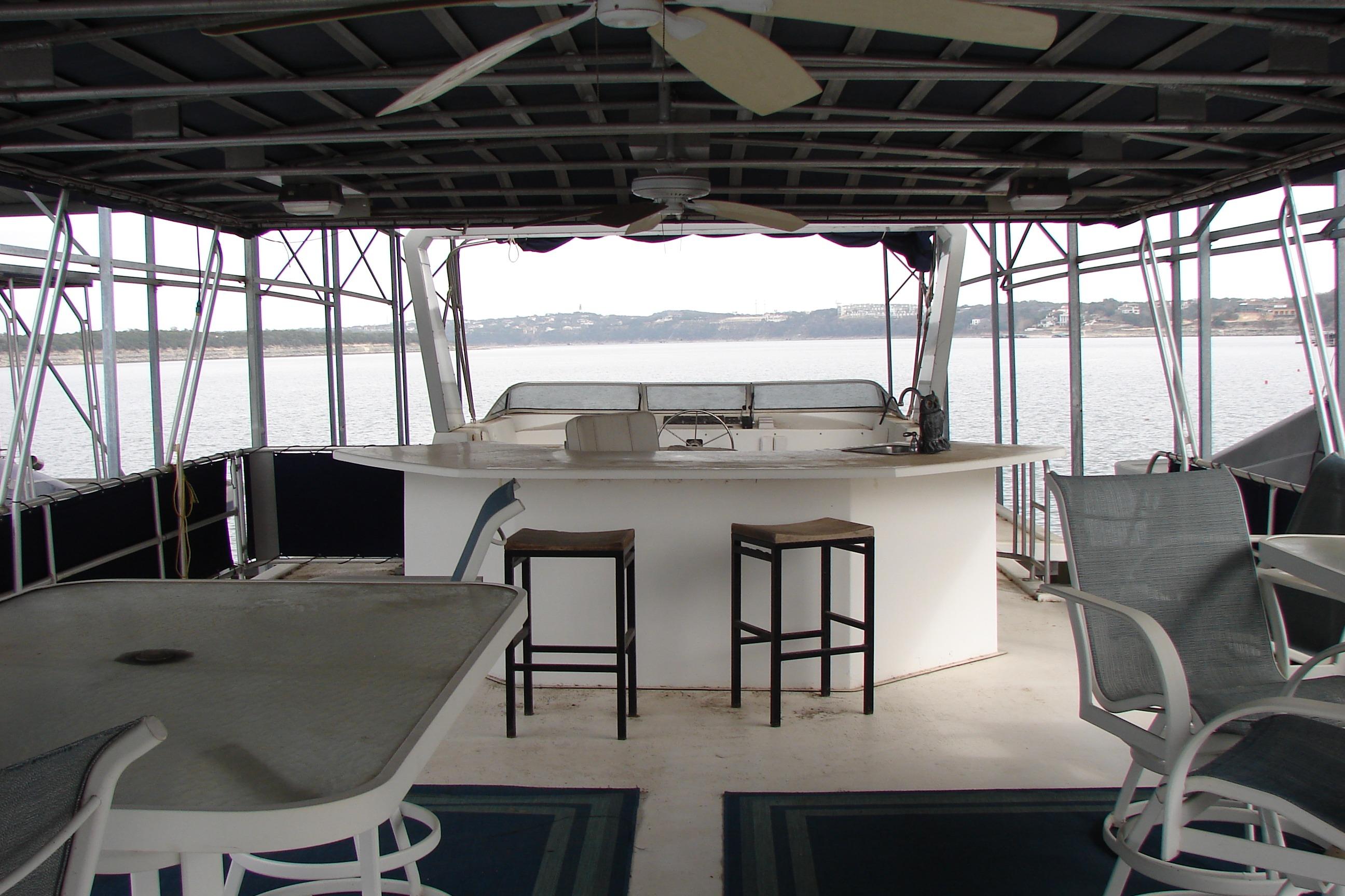 1999 Sumerset 18x90 houseboat interior with bar, stools, and lake view.