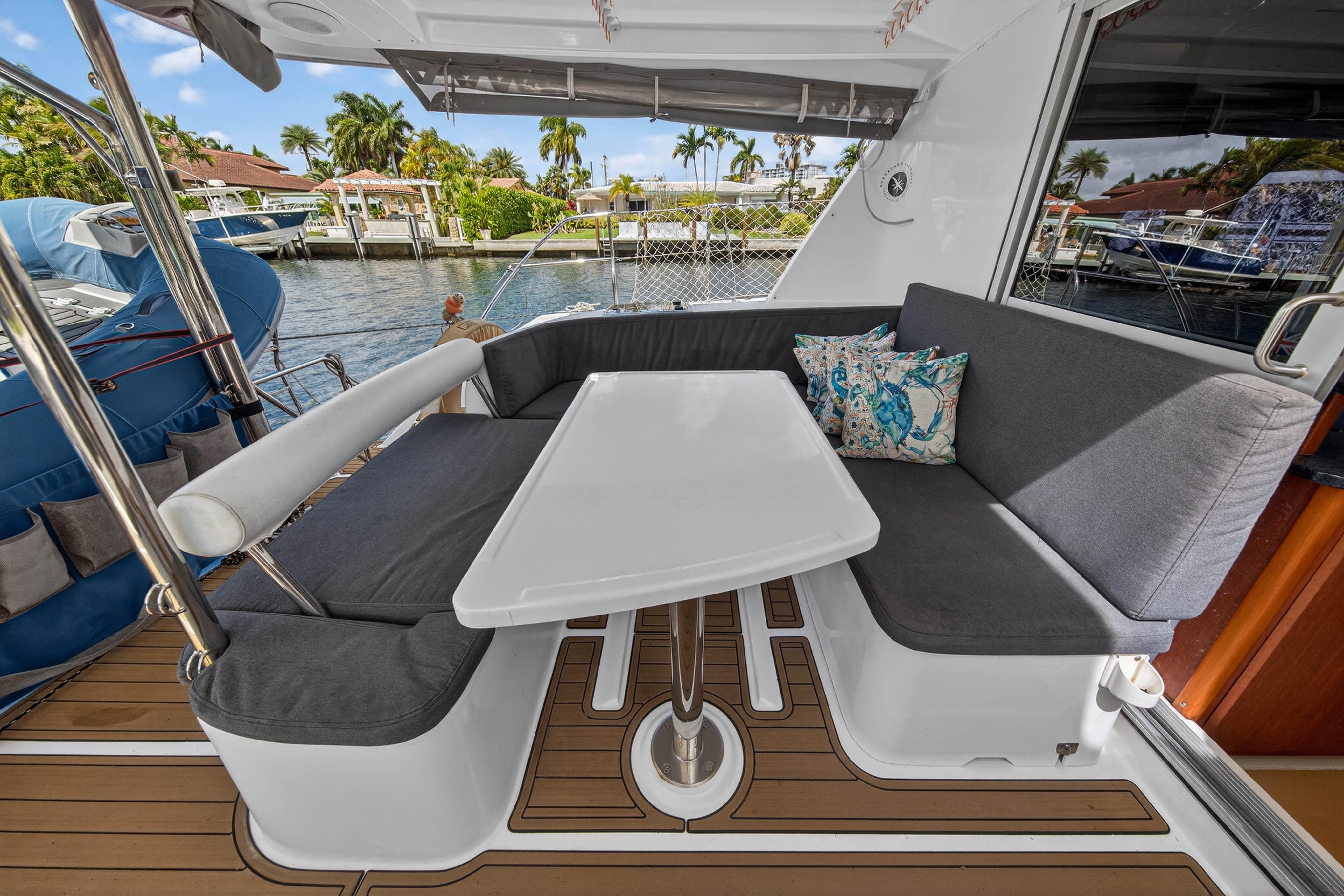 Cozy seating area on a 2012 Leopard 39 yacht with a waterfront view.