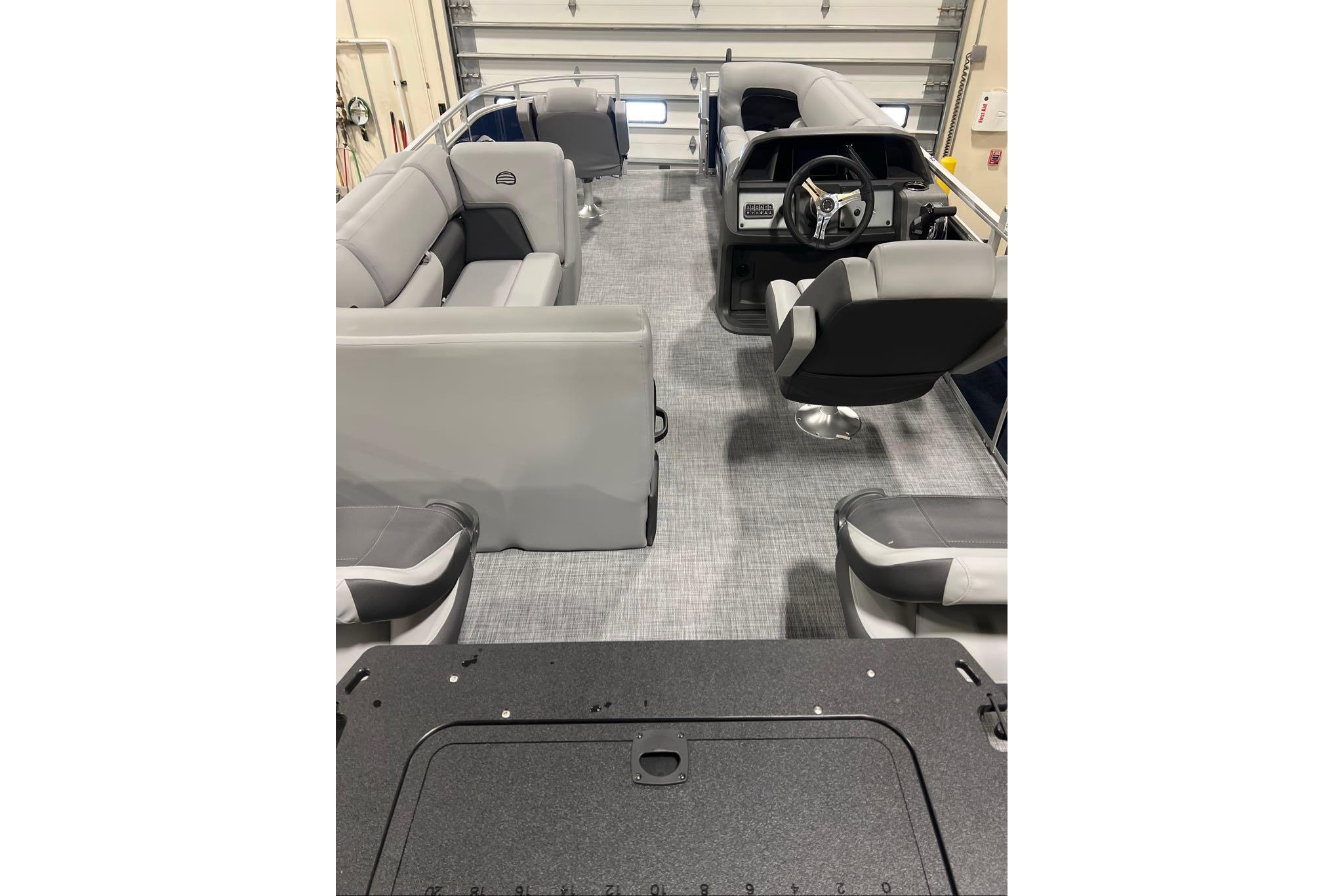 2026 Sun Tracker SportFish 20 DLX interior with gray seating and steering console.