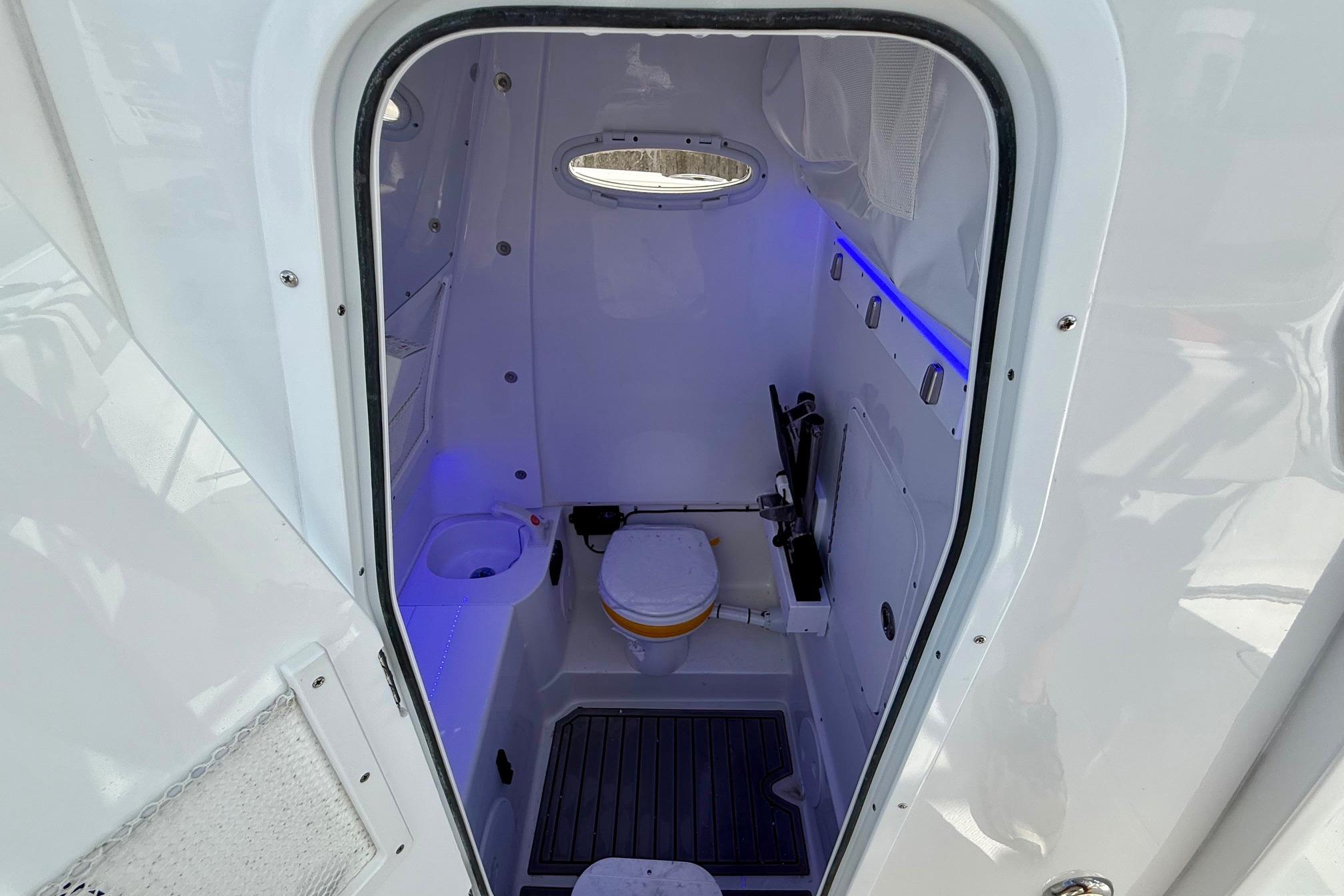 Interior of 2026 Sea Hunt Ultra 285 Coffin Box boat bathroom with modern amenities.