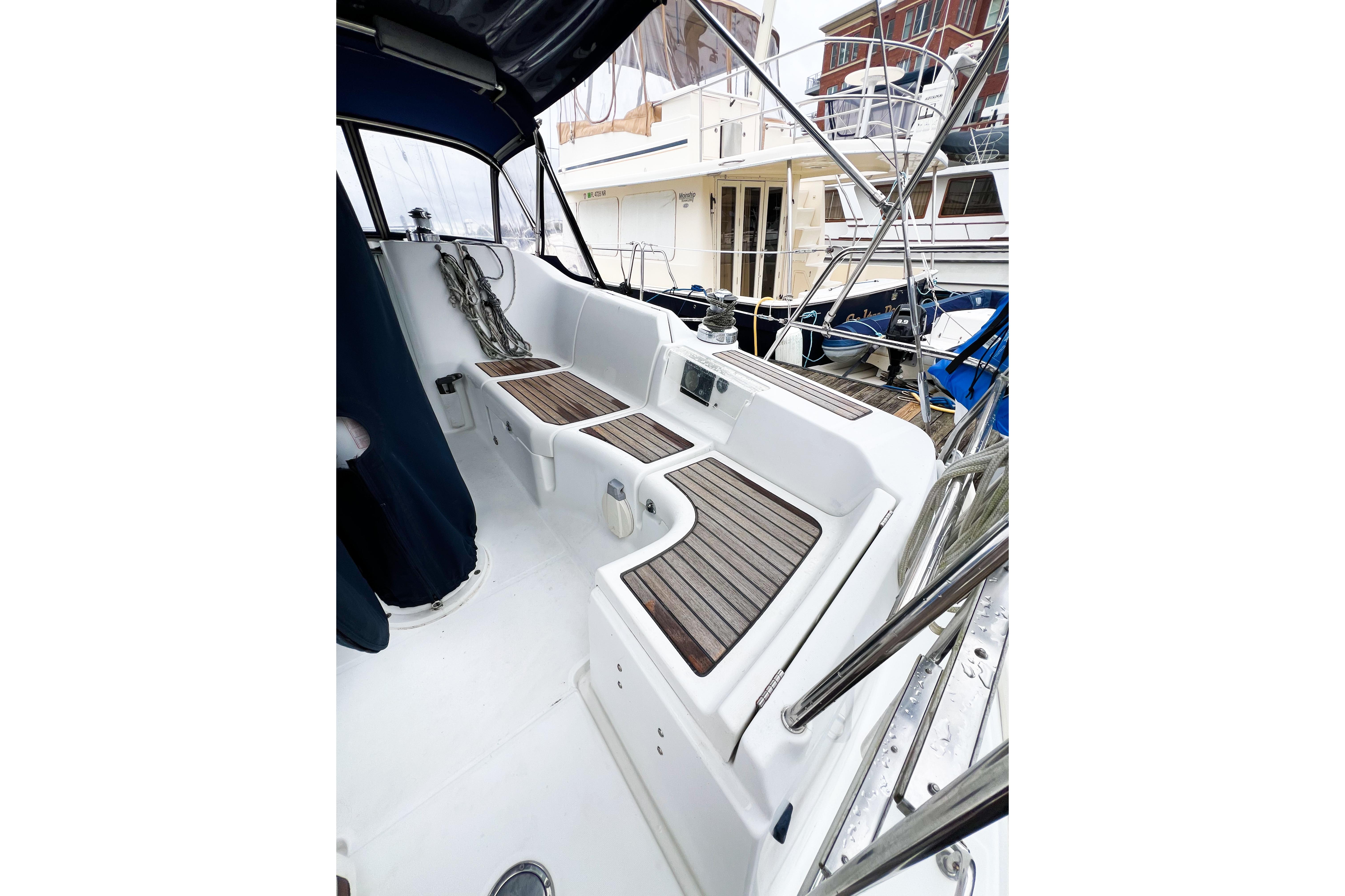 2007 Beneteau 373 sailboat cockpit with teak seating and nautical equipment.