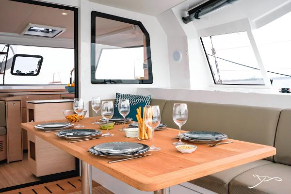 Luxurious dining area on 2025 Nautitech 40 Open catamaran, featuring elegant table setting.