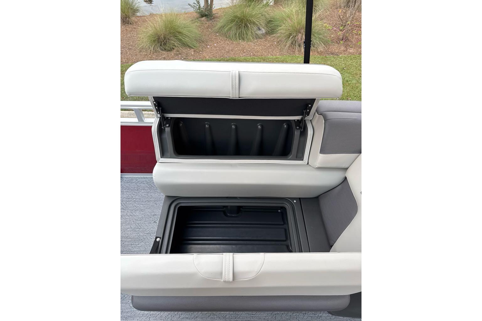 2026 Sun Tracker Fishin' Barge 22 DLX seat storage compartment open, showcasing interior space.