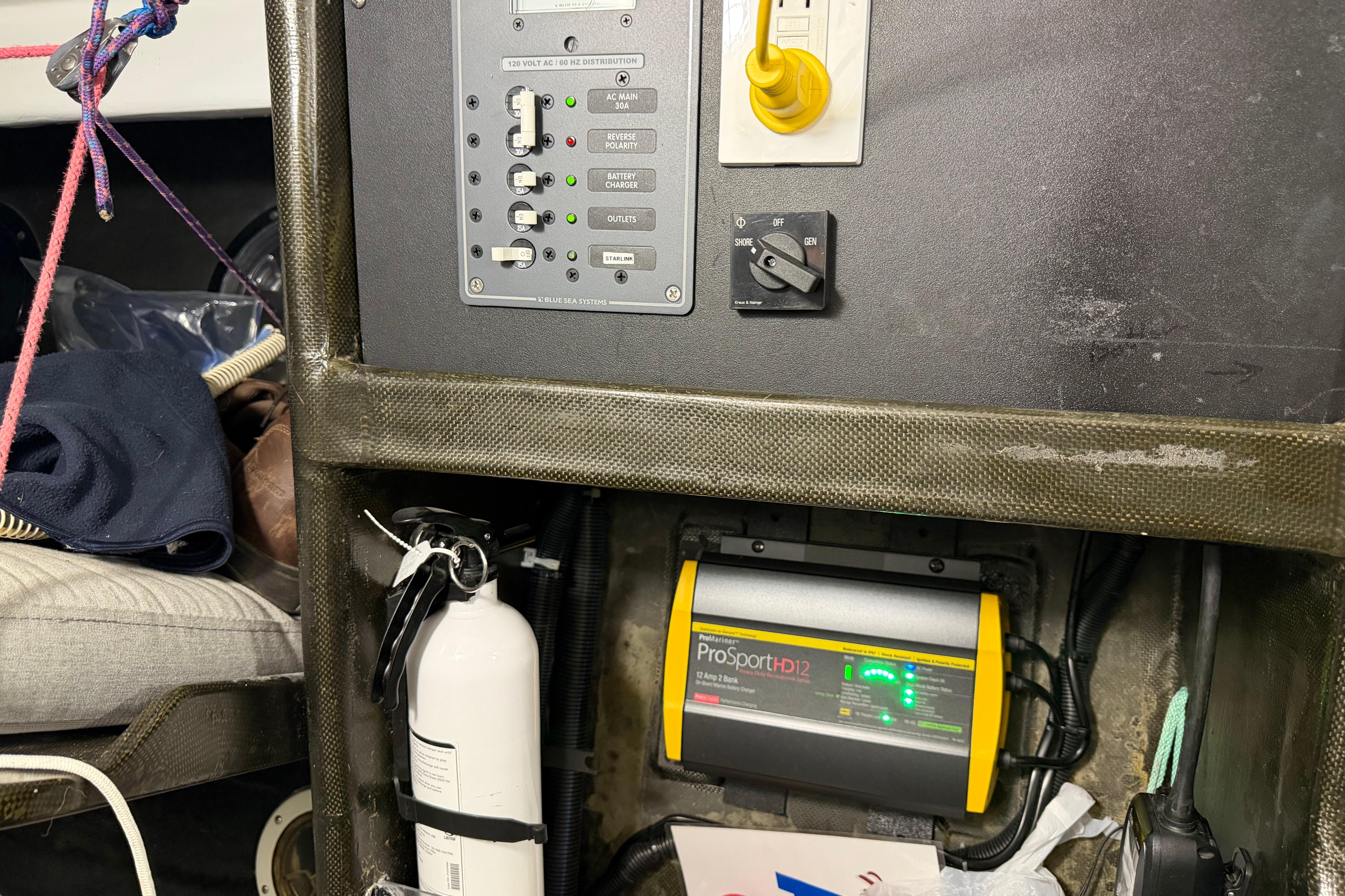 Electrical panel and ProSportHD12 charger in Andrews 63 boat interior.