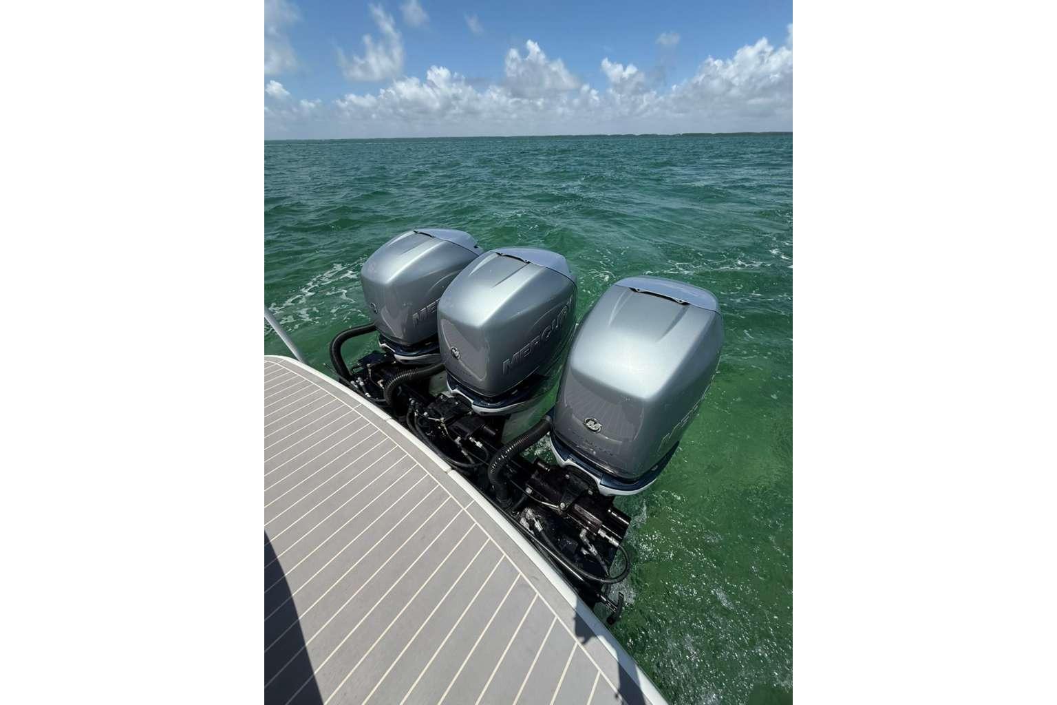 2022 Formula 350 Crossover Bowrider OB with triple outboard motors on open water.
