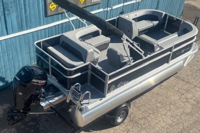 2026 Sun Tracker Party Barge 18 DLX pontoon boat with Mercury outboard motor.