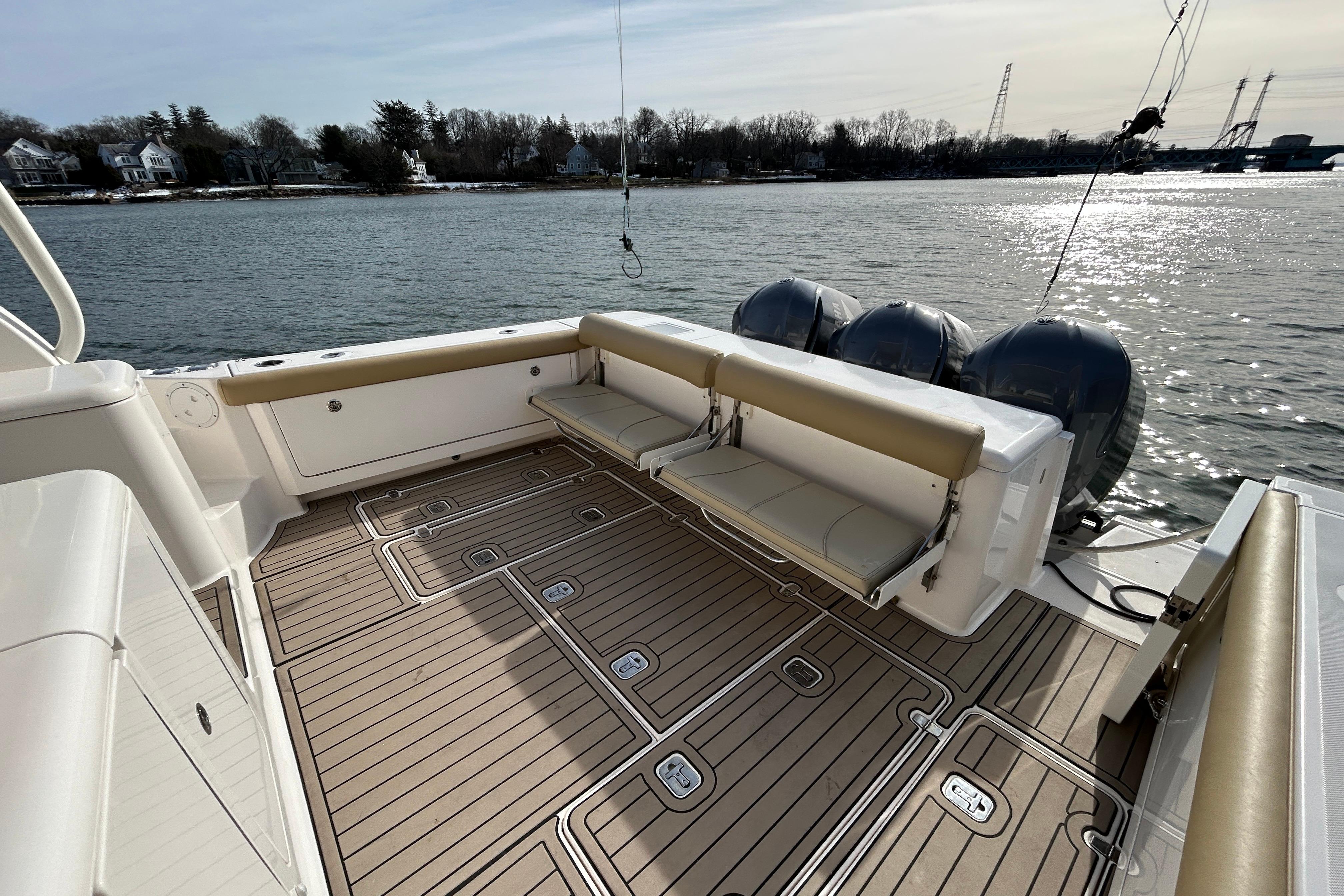 2018 Pursuit OS 385 Offshore boat deck with seating, overlooking calm waters.