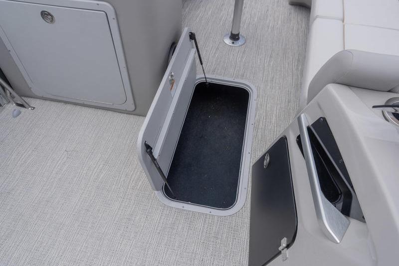 Open storage compartment on 2026 SunCatcher Elite 326 SS boat interior.