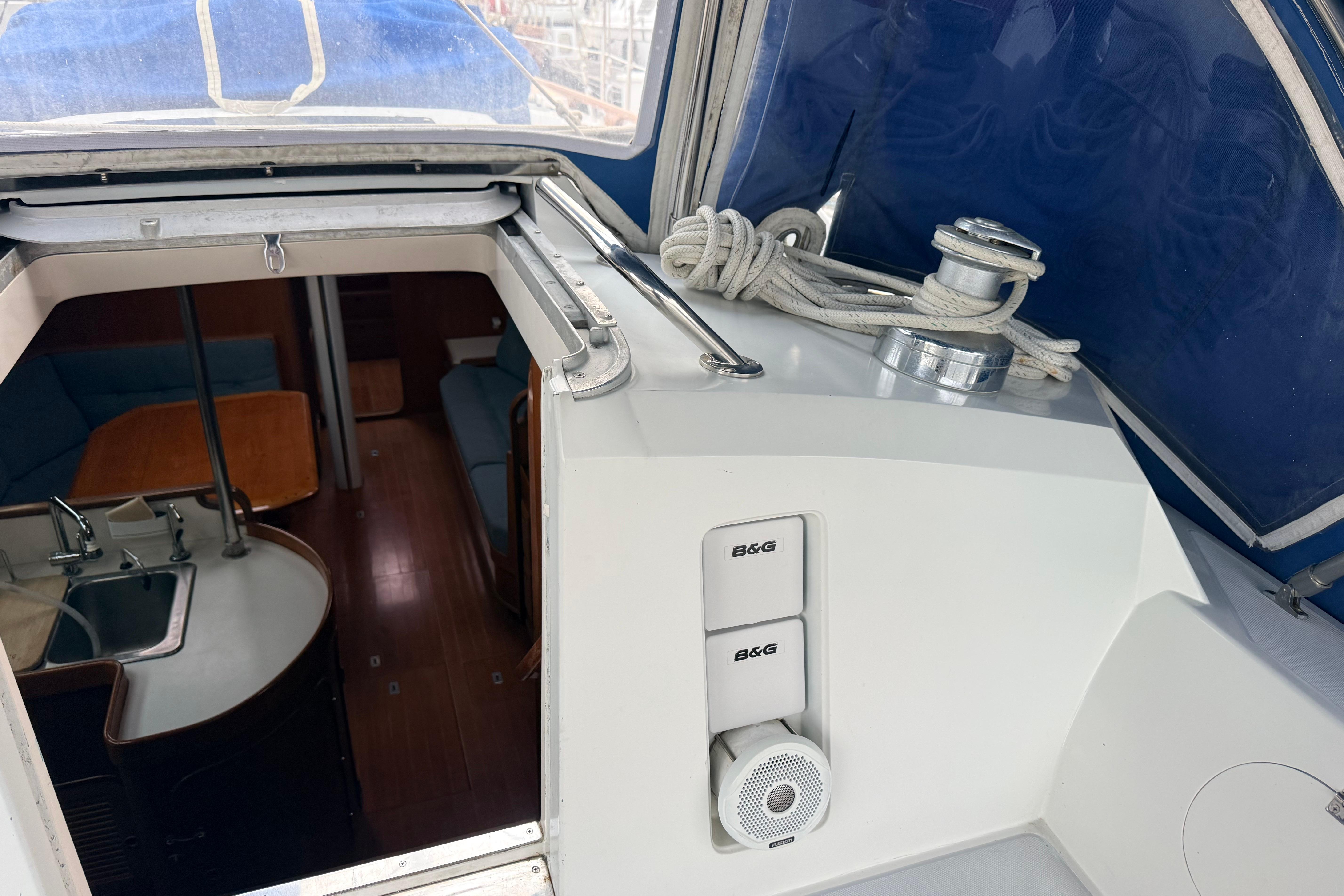 Interior view of 1987 Norseman 400 sailboat with kitchen and seating area.