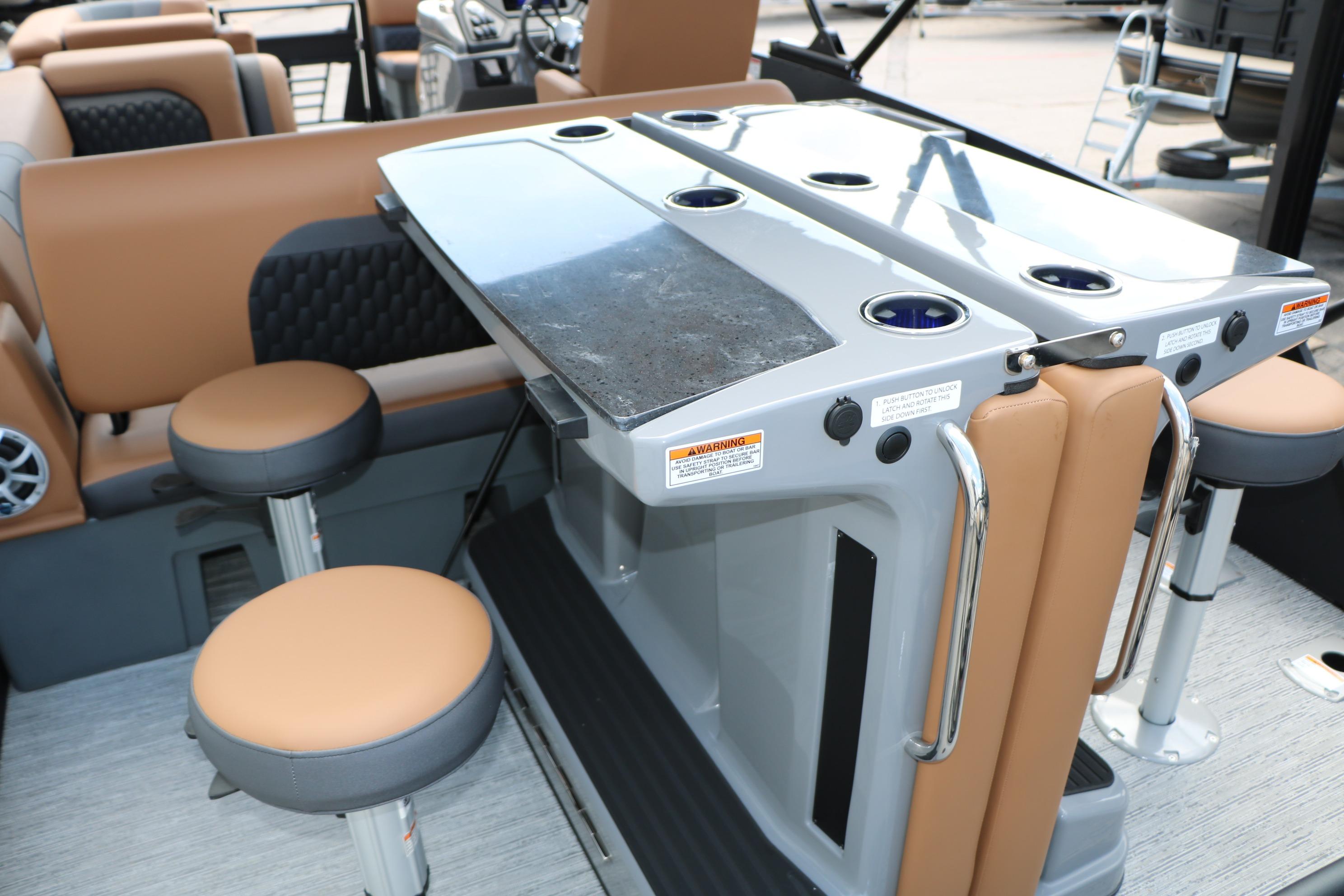 2026 Sylvan L3 DLZ Bar Platinum Edition Tri-Toon interior with bar seating and table.