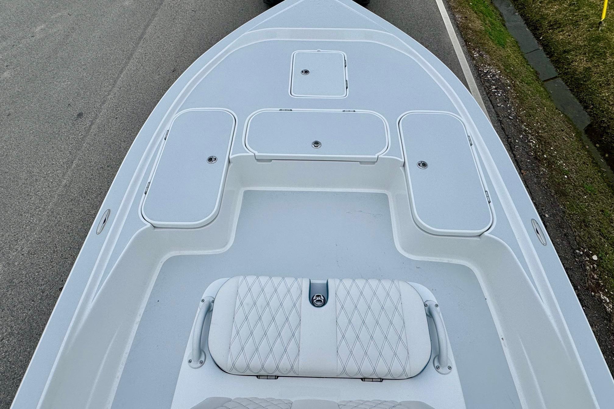 2026 Shallow Sport 24 Modified V boat deck with storage compartments and seating.