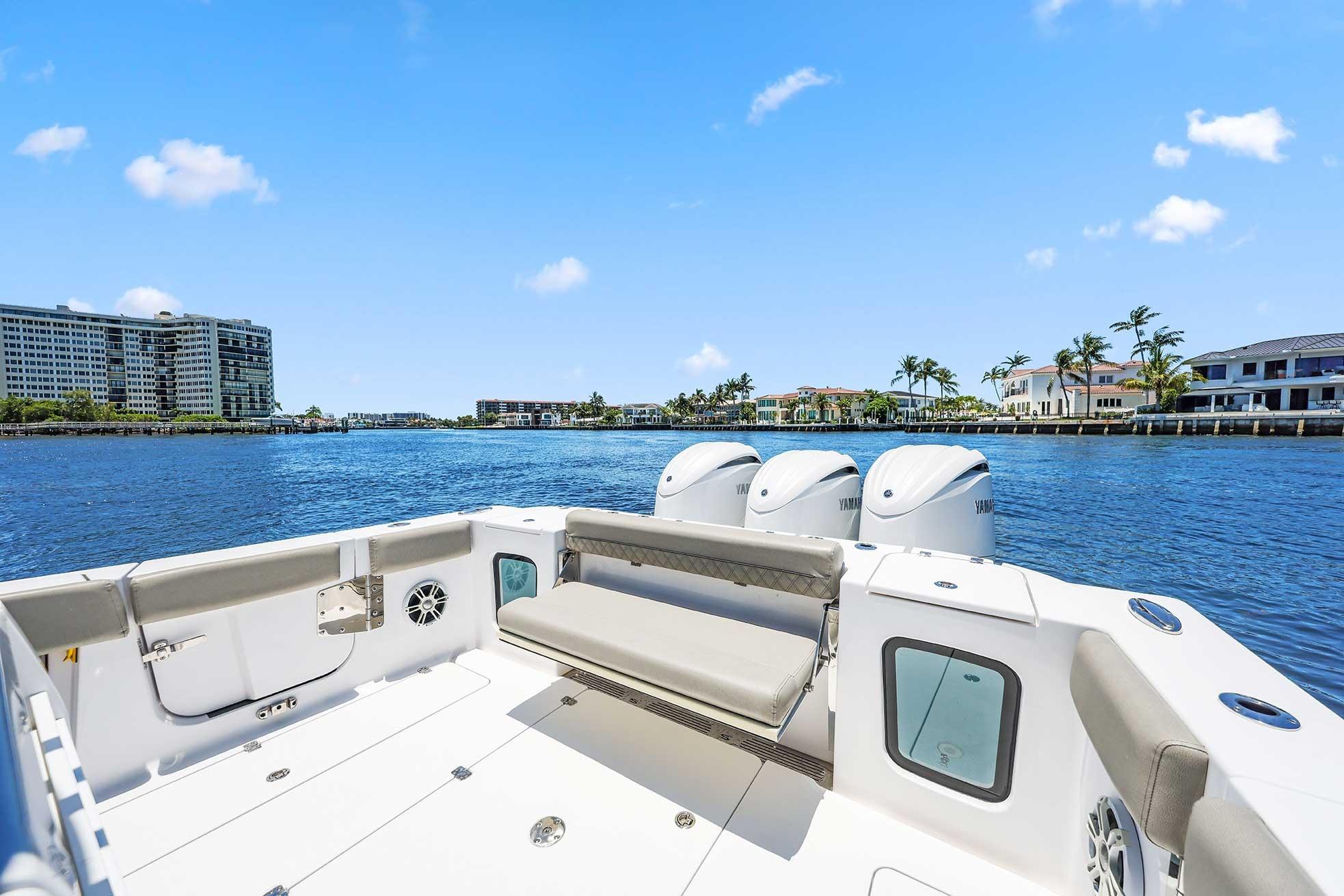 2024 Sportsman Open 352 Center Console boat on a sunny waterfront.