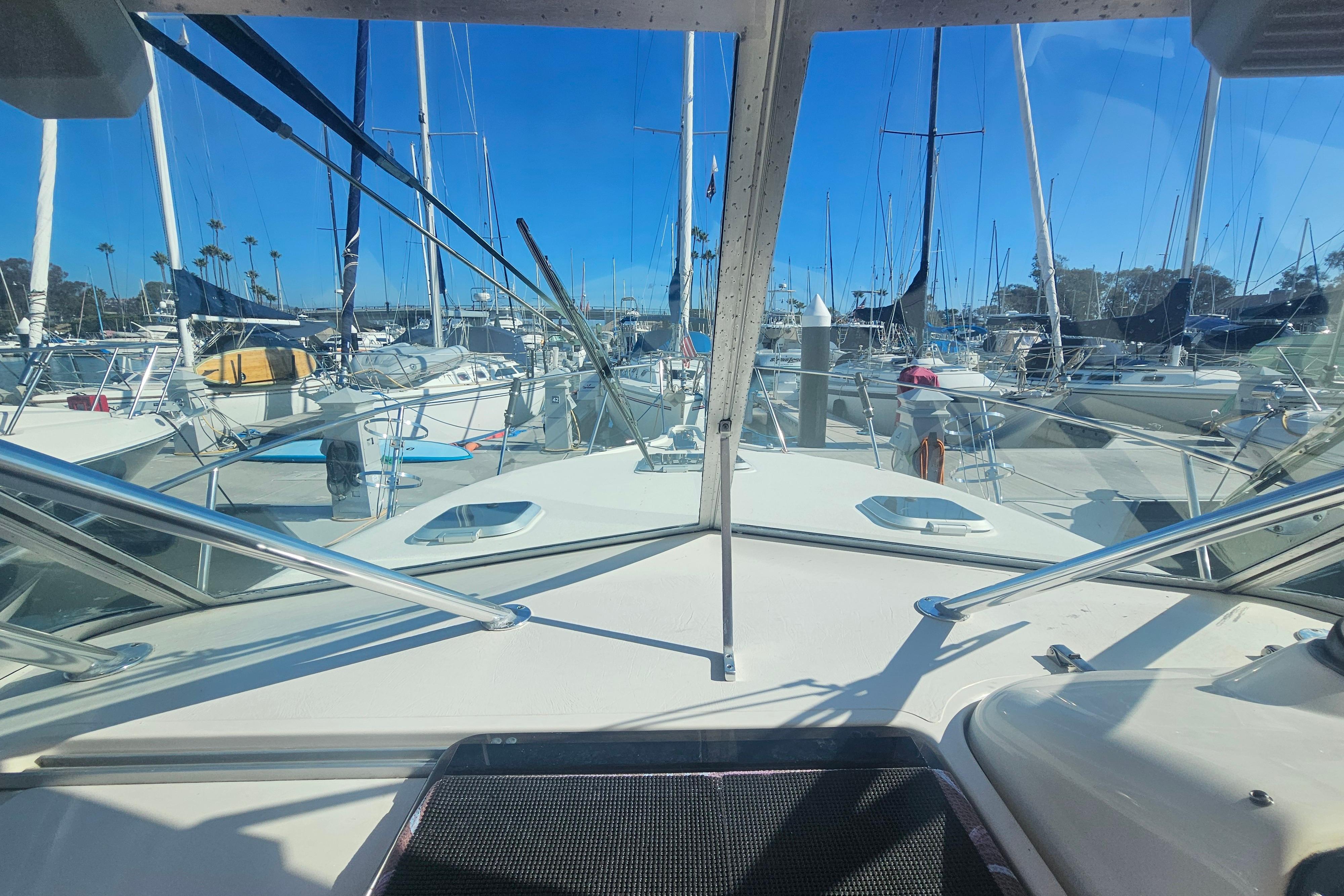 2001 Pursuit 3000 Express boat docked in a marina with clear blue skies.