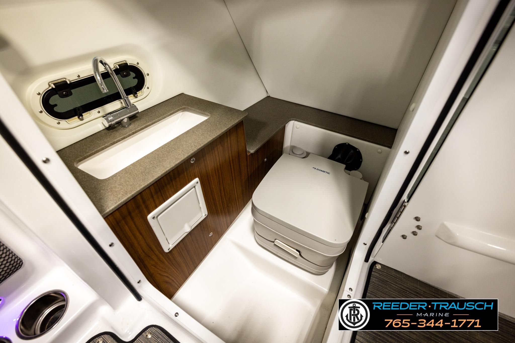 2024 FOURWINNS HD5 Surf boat interior with sink and portable toilet.