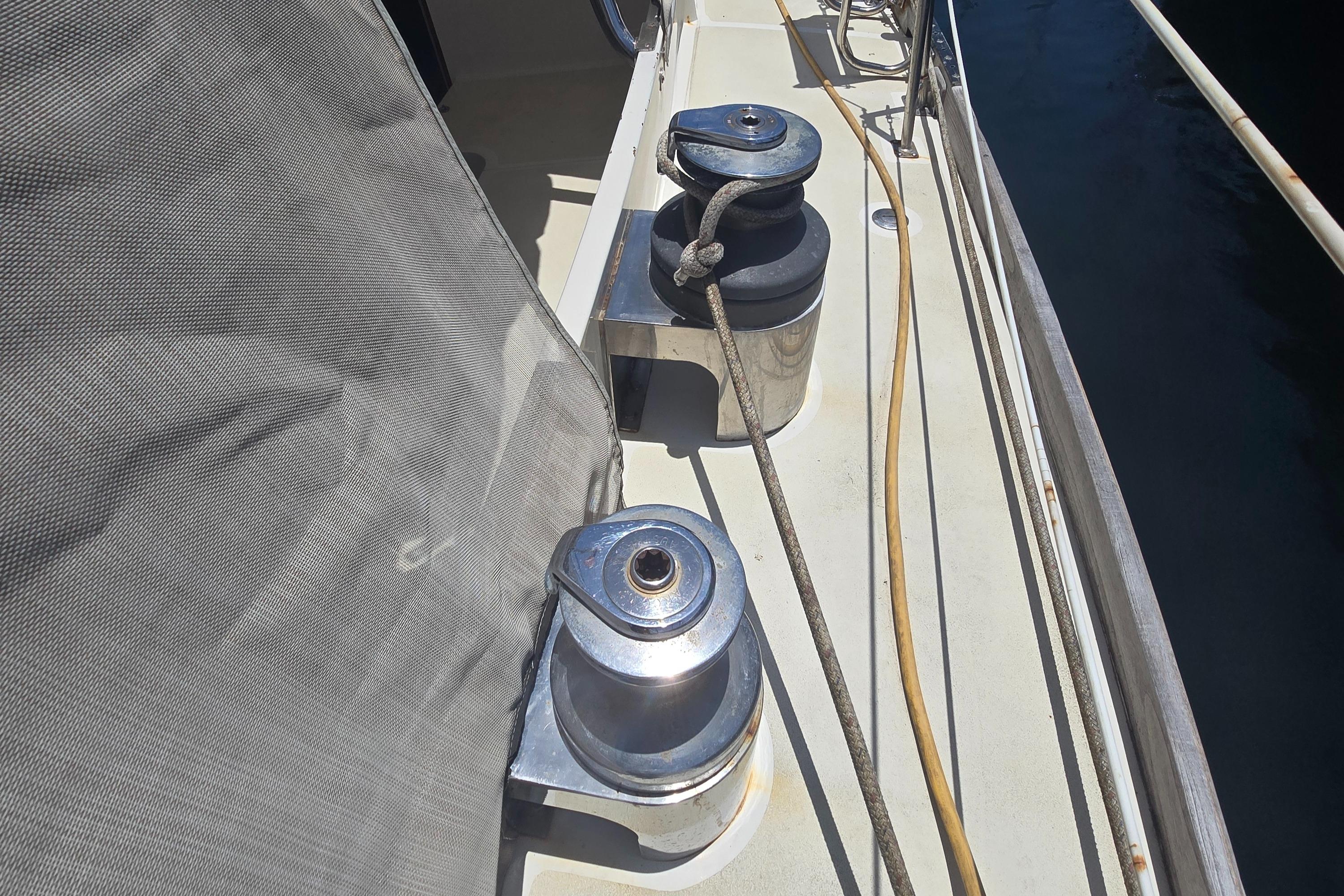 Winches on a 1978 Herreshoff 50 sailboat deck, with ropes and cover visible.