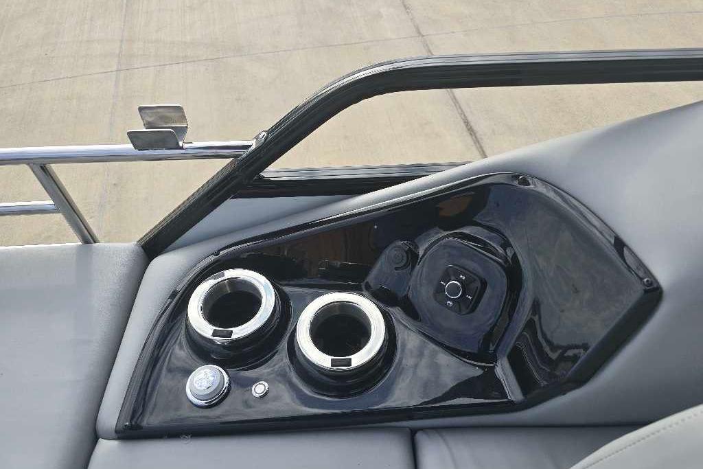 Control panel of 2025 Regency 250 LE3 Sport boat with cup holders and controls.