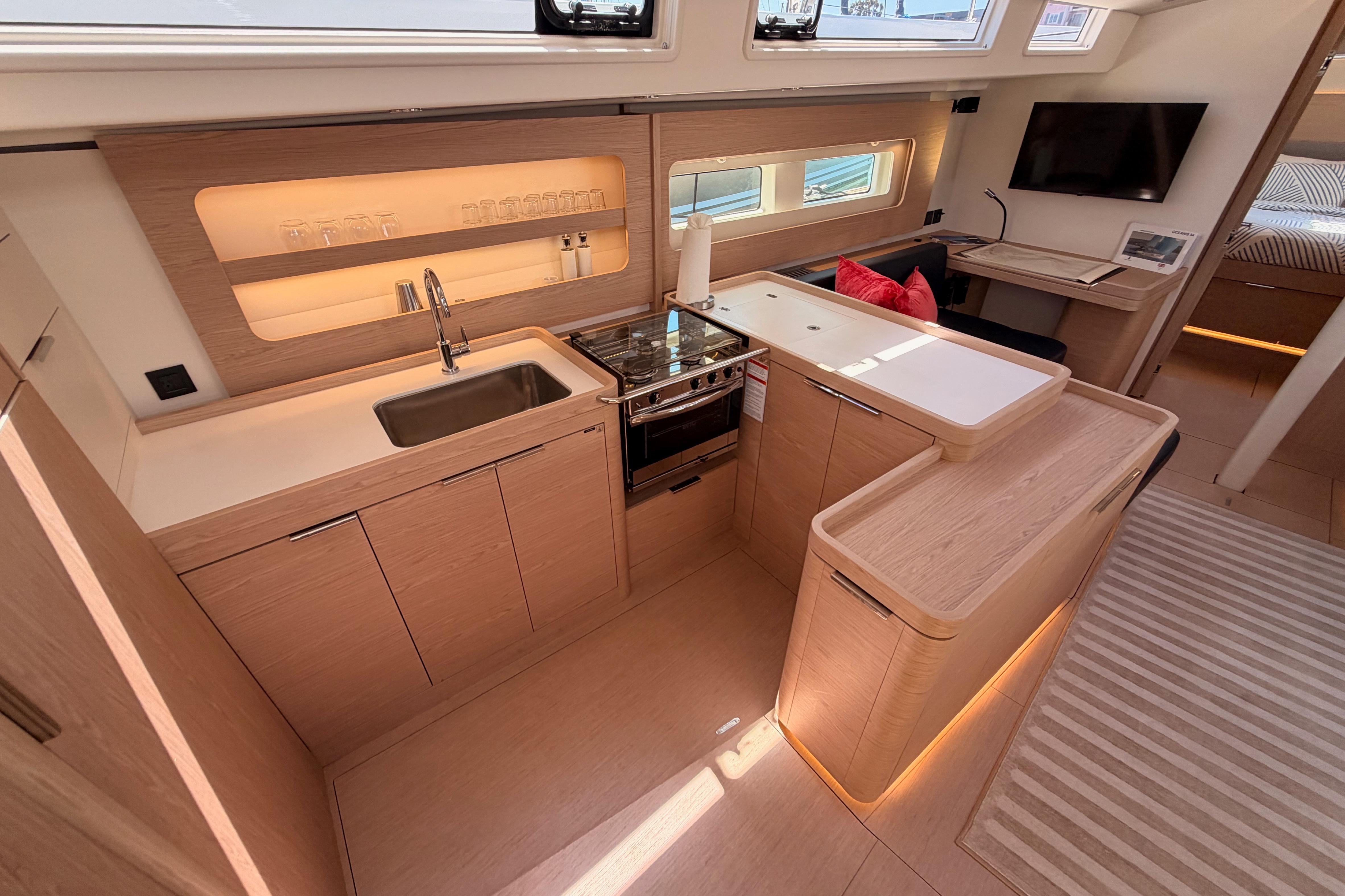 Luxurious interior of 2022 Beneteau Oceanis Yacht 54 with modern kitchen and elegant design.