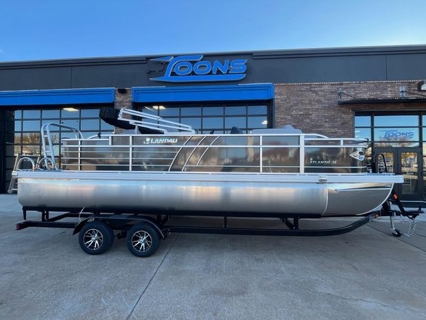 2025 Landau Atlantis 23C Cruise pontoon boat in front of a store.