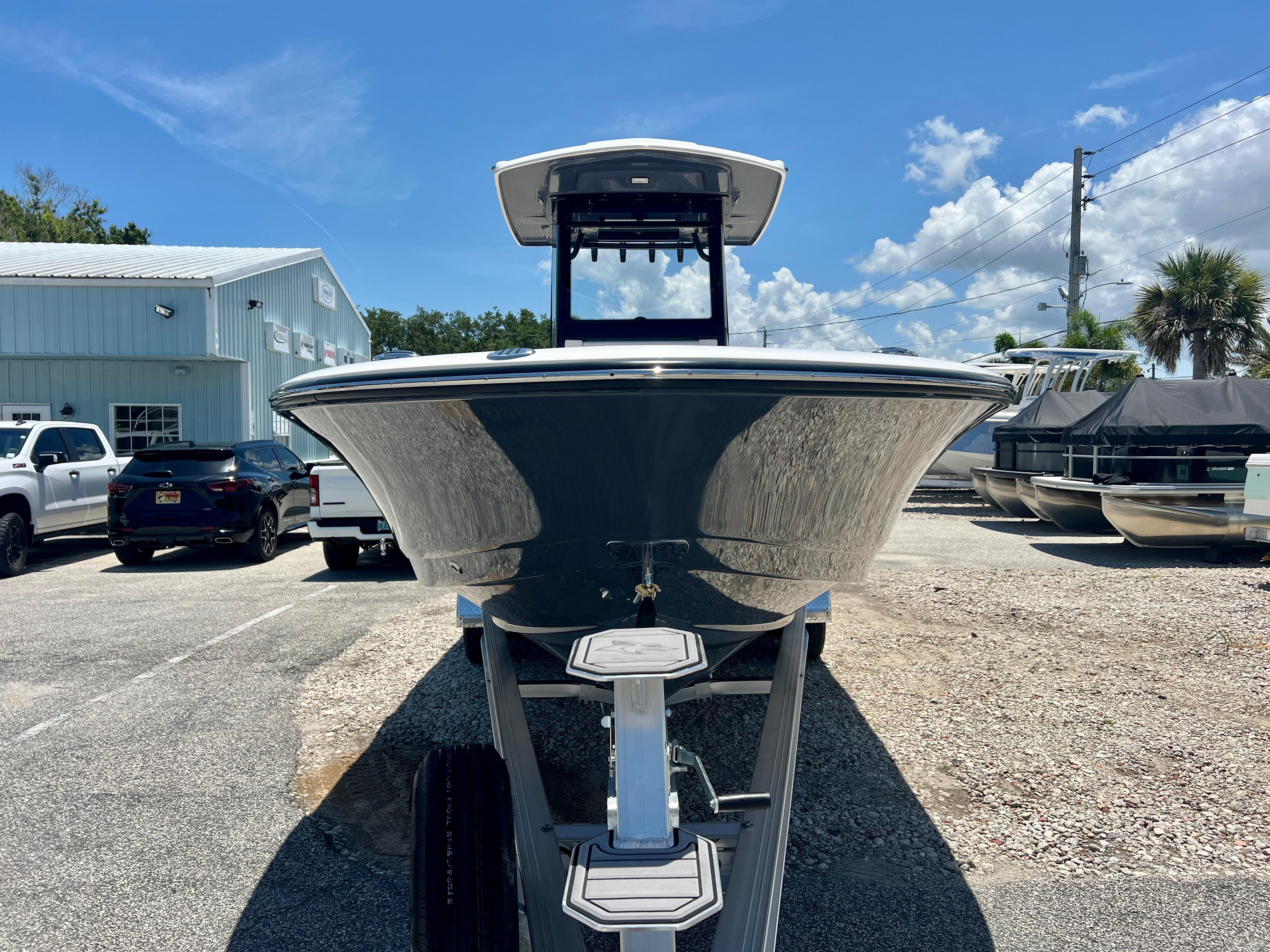 2025 Robalo 266 Cayman boat on a trailer outdoors.