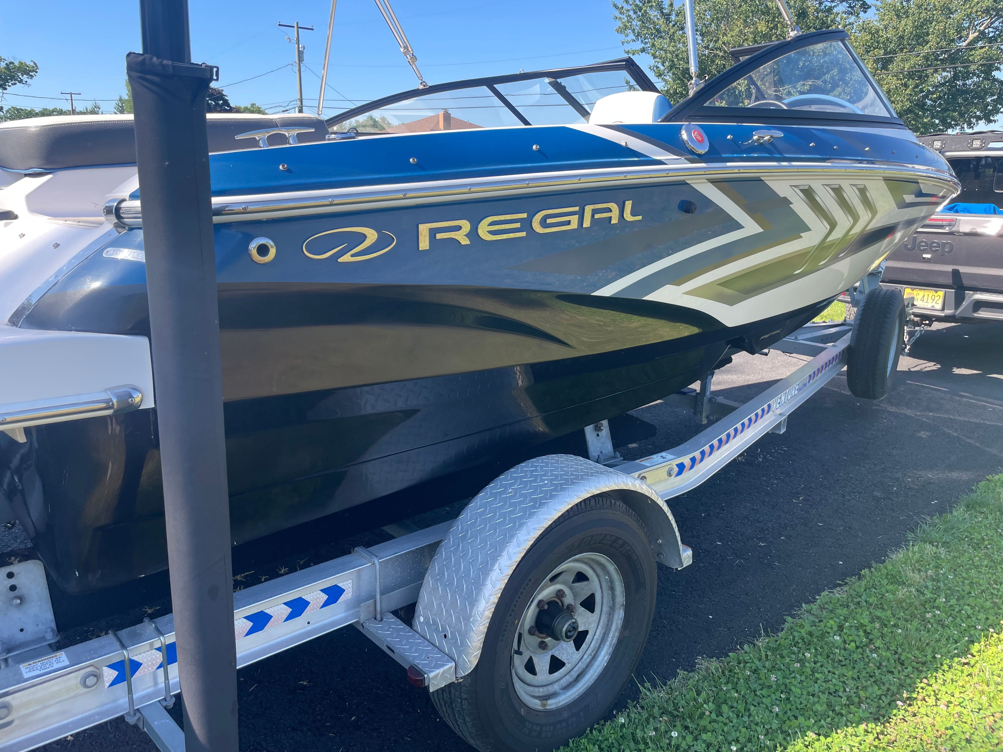 A 2016 Regal 1900 ESX Bowrider on a trailer, ready for the water.