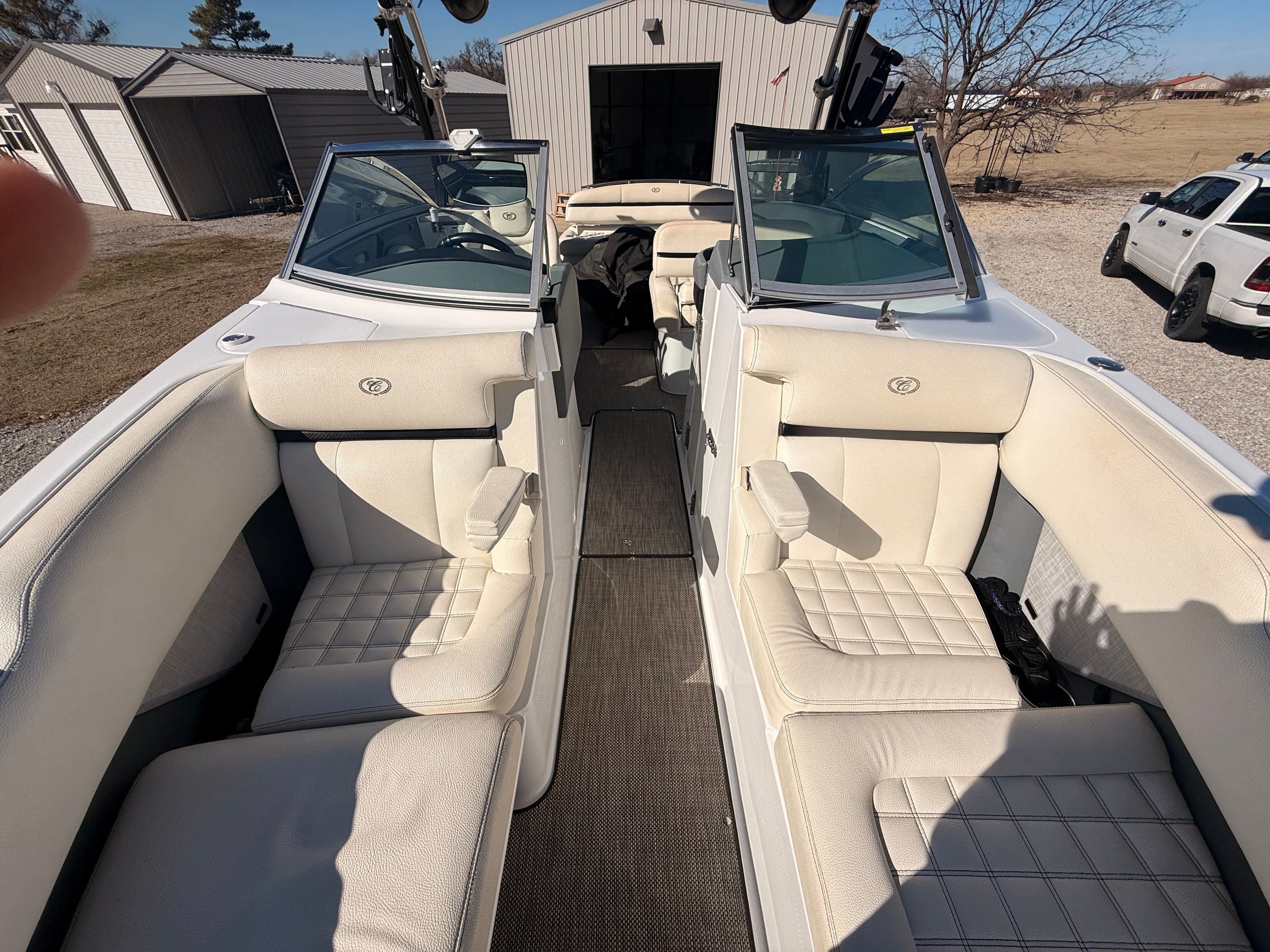 The image shows the interior of a 2019 Cobalt R7 Surf boat with white leather seats.